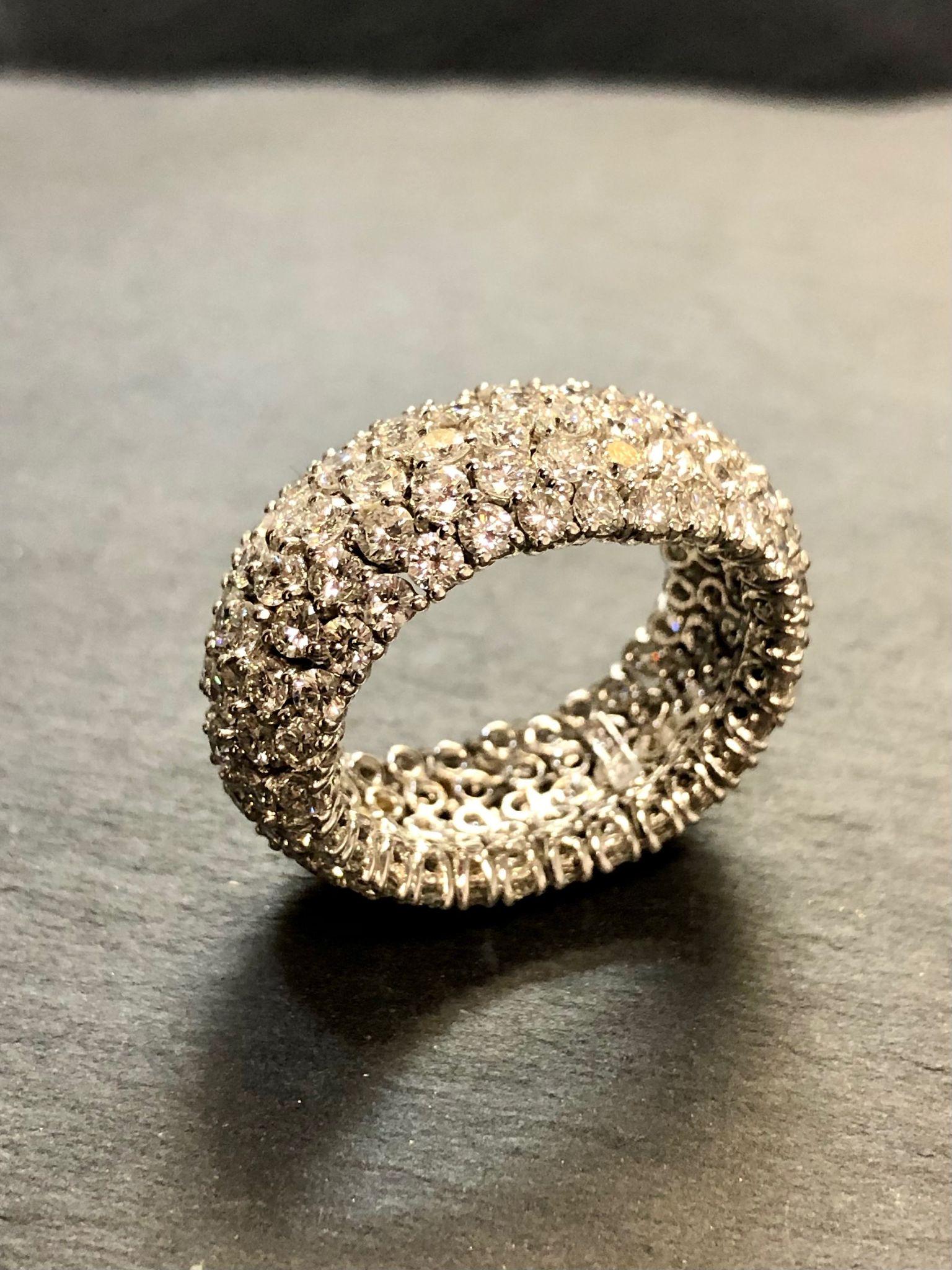 A beautifully made flexible wide band done in 18K and individually prong set with approximately 7cttw in H-J color Vs1-Si1 clarity round diamonds.

Dimensions /Weight
10.50mm wide. Size 6. Weighs 6.4dwt.

Condition
All stones are secure. Perfectly