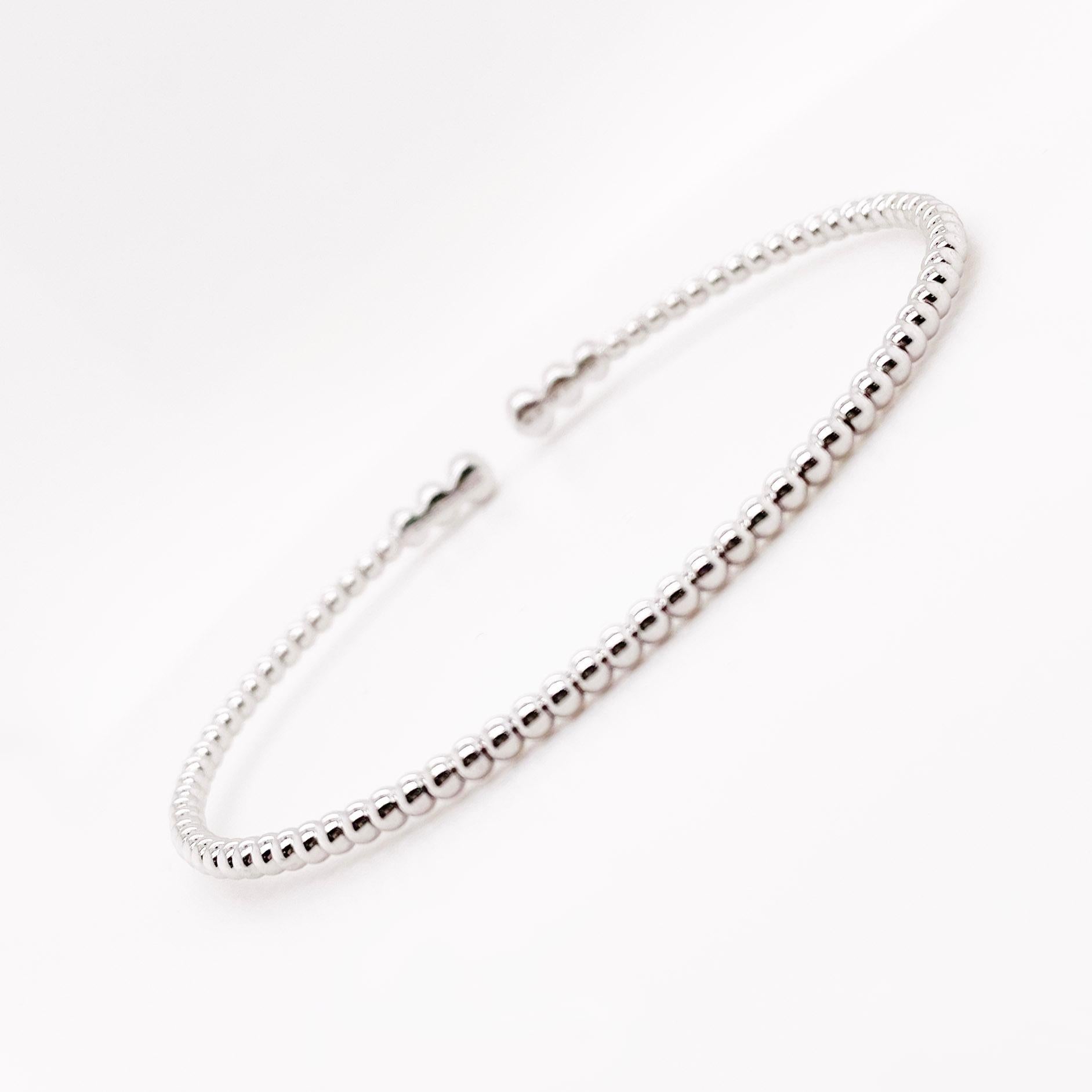 This 14k white gold flex bracelet has 6 diamonds on the top of the bracelet and the rest of the design is beaded.  The patented wire design does not require a clasp as the 14 karat wire hugs your wrist. Many times people will pair this bracelet with