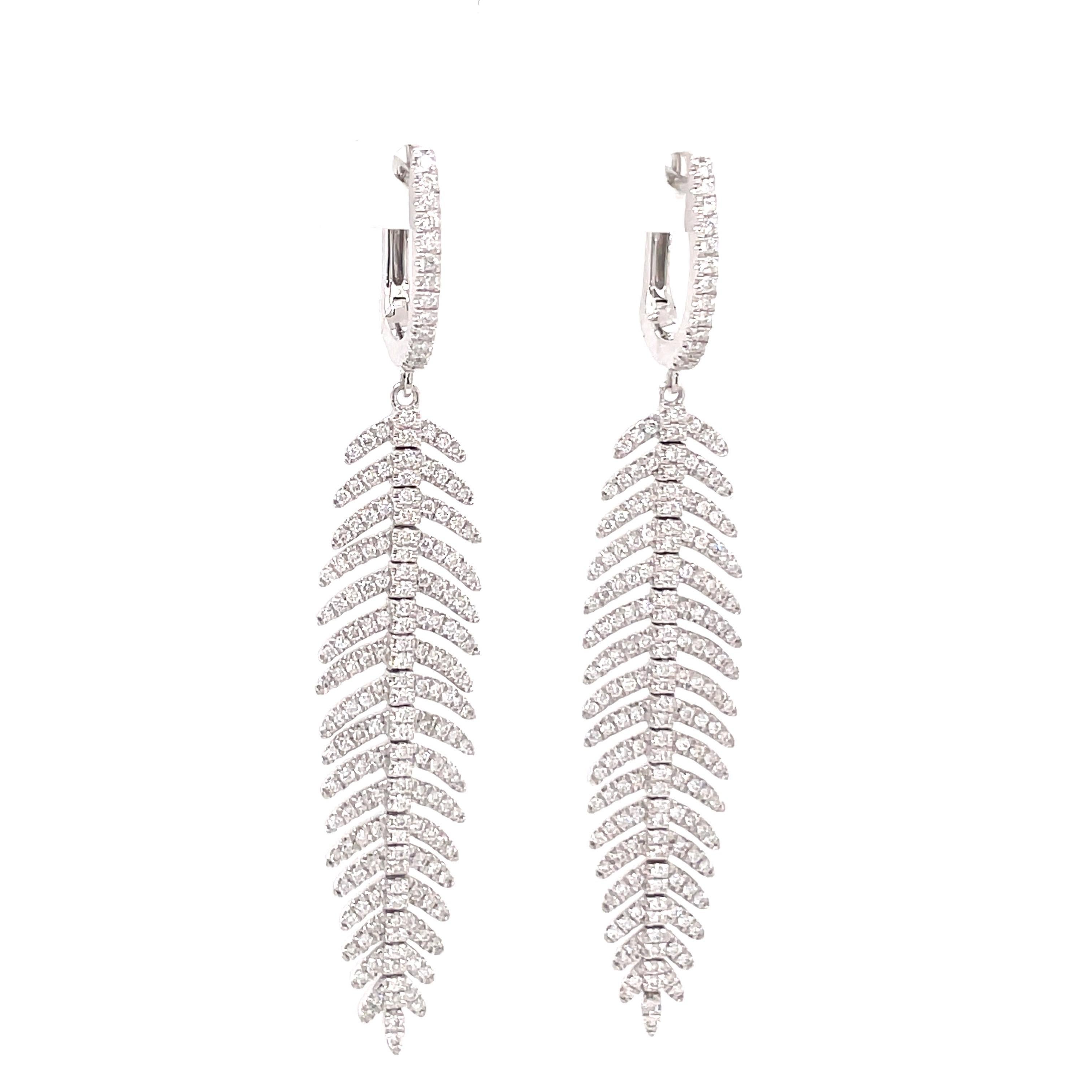 14 Karat White Gold drop earrings featuring 358 round brilliants in a feather motif weighing 1.28 carats.
Color G-H
Clarity SI

Available in yellow gold. 