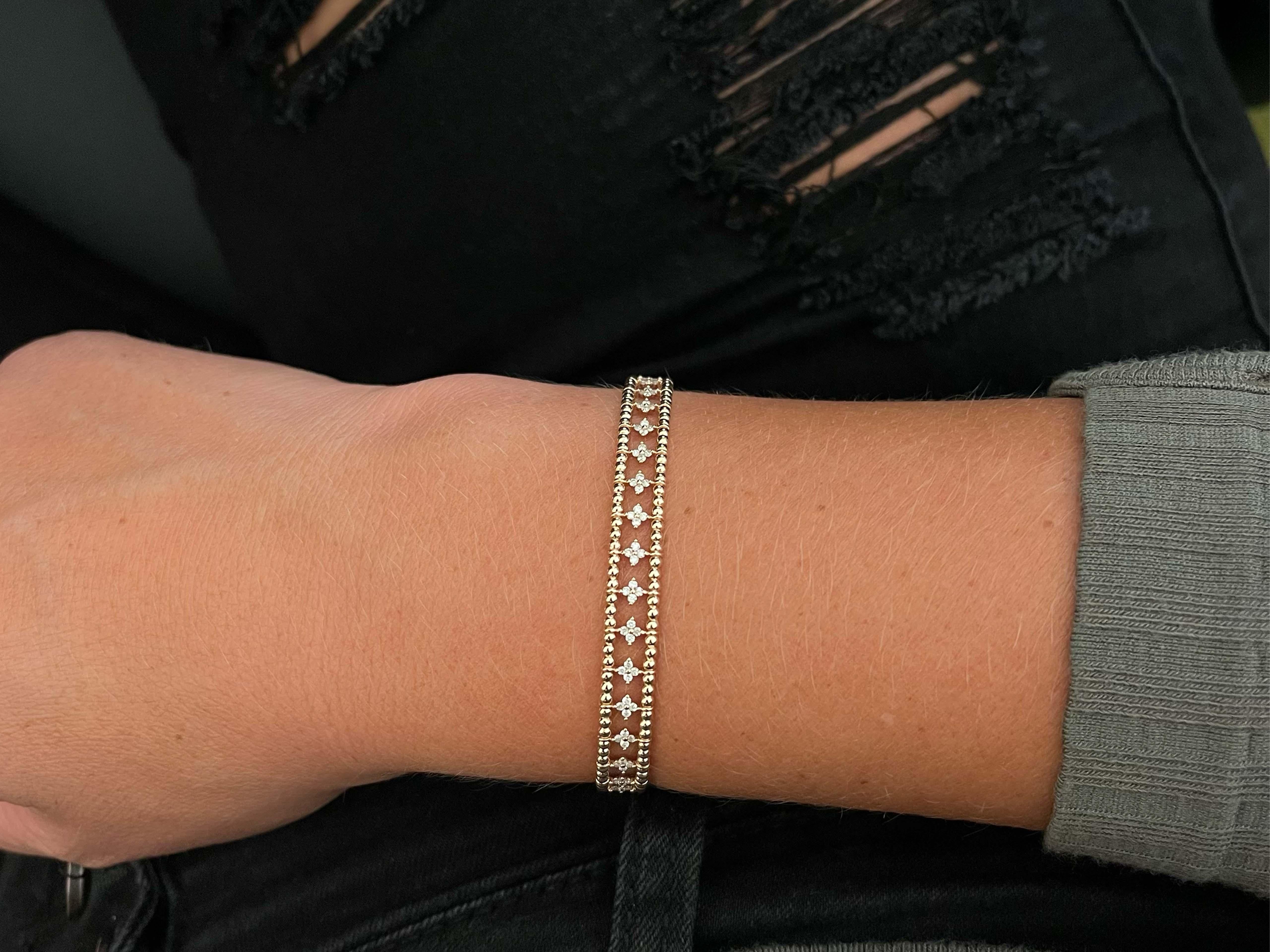 This beautiful flexible bracelet features numerous diamonds in flower shapes weighing a total of ~0.75 carats. The diamonds are G-H in color and VS in clarity. The bracelet is equipped with a slide latch clasp. The inside diameter measures 59 mm by