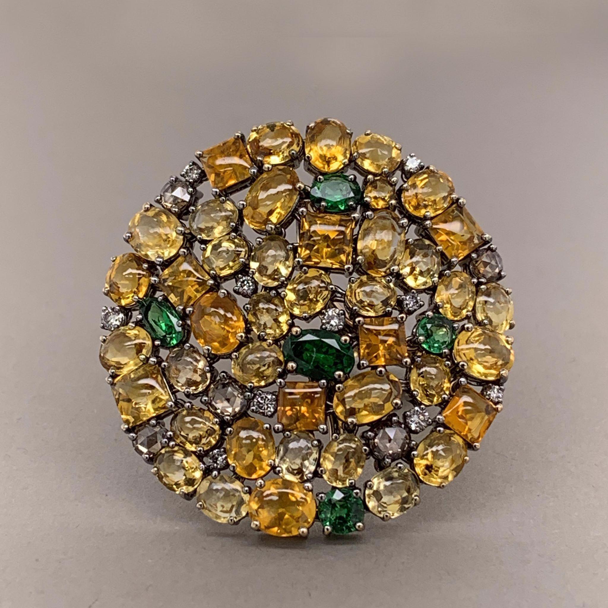 A special treat! This gemset ring features 19.63 carats of diamonds, tsavorite garnets, and orange/yellow sapphires. Each of the rings settings are connected with small hinges allowing the flat top to flex and move ever so slightly. Hand fabricated
