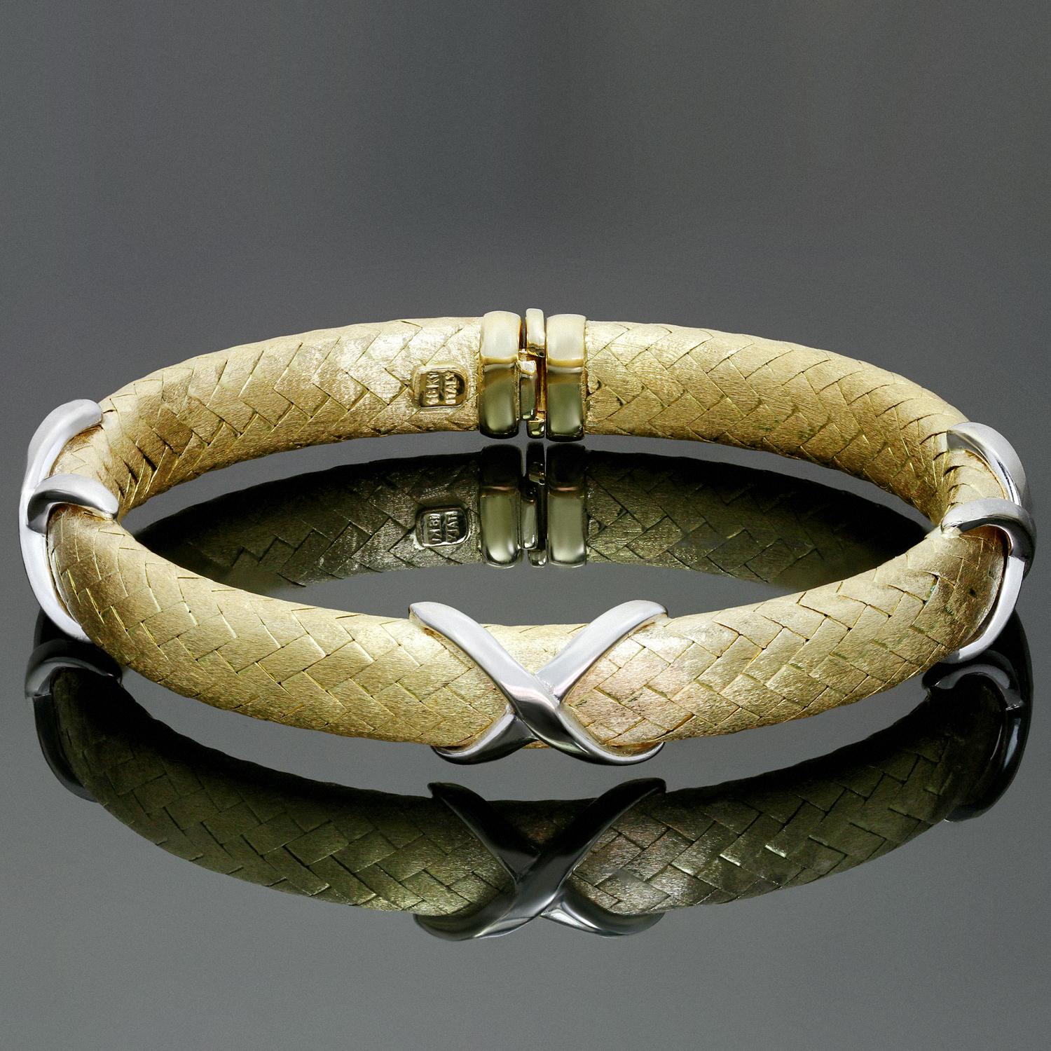 This classic flexible bracelet is crafted in textured 18k yellow gold and accented with X motifs in polished white gold. Makers mark ZRW. Made in Italy circa 1980s. Measurements: 0.51