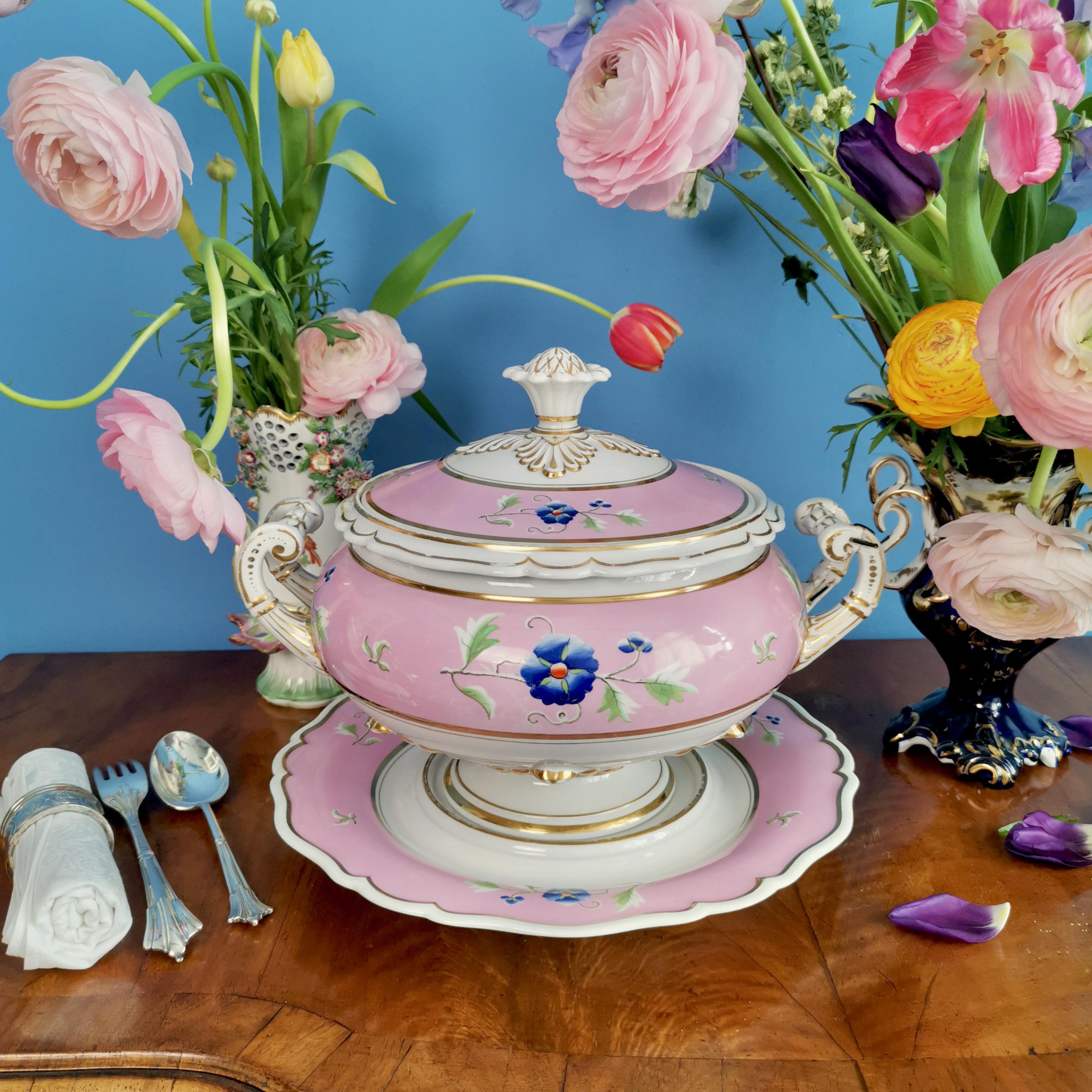 This is a gorgeous large soup tureen with cover and stand made by Flight, Barr & Barr in around 1820. The set is decorated in a bright pink ground with charming blue flower sprigs. The tureen is excellent for use at the dinner table, but would also