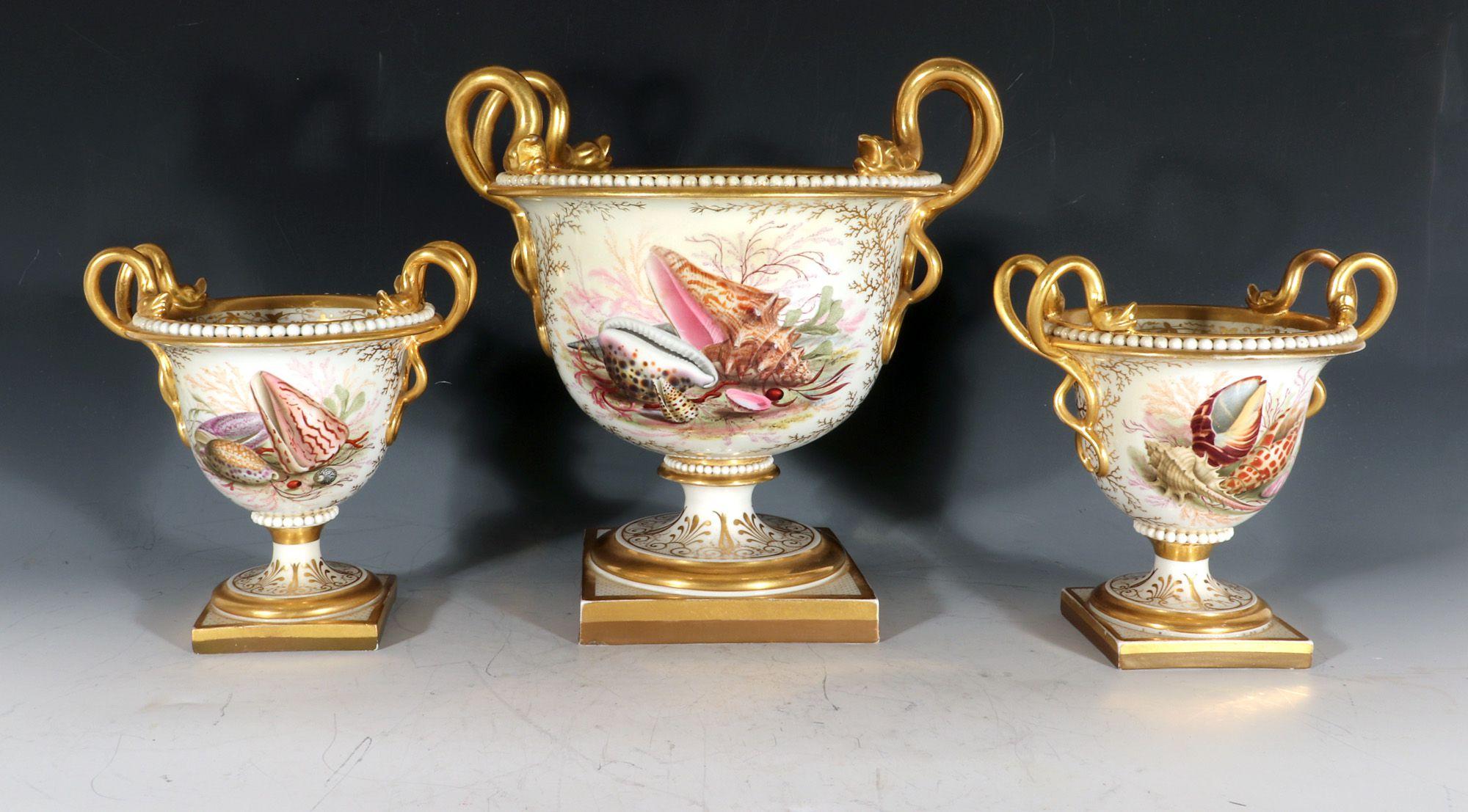 Flight, Barr & Barr Worcester Porcelain sea shell Garniture of Urns,
Circa 1813-19

The set of three urns have a central painting of sea shells and seaweed, each with a gilt seaweed ground with a taller central urn and a pair of smaller urns that