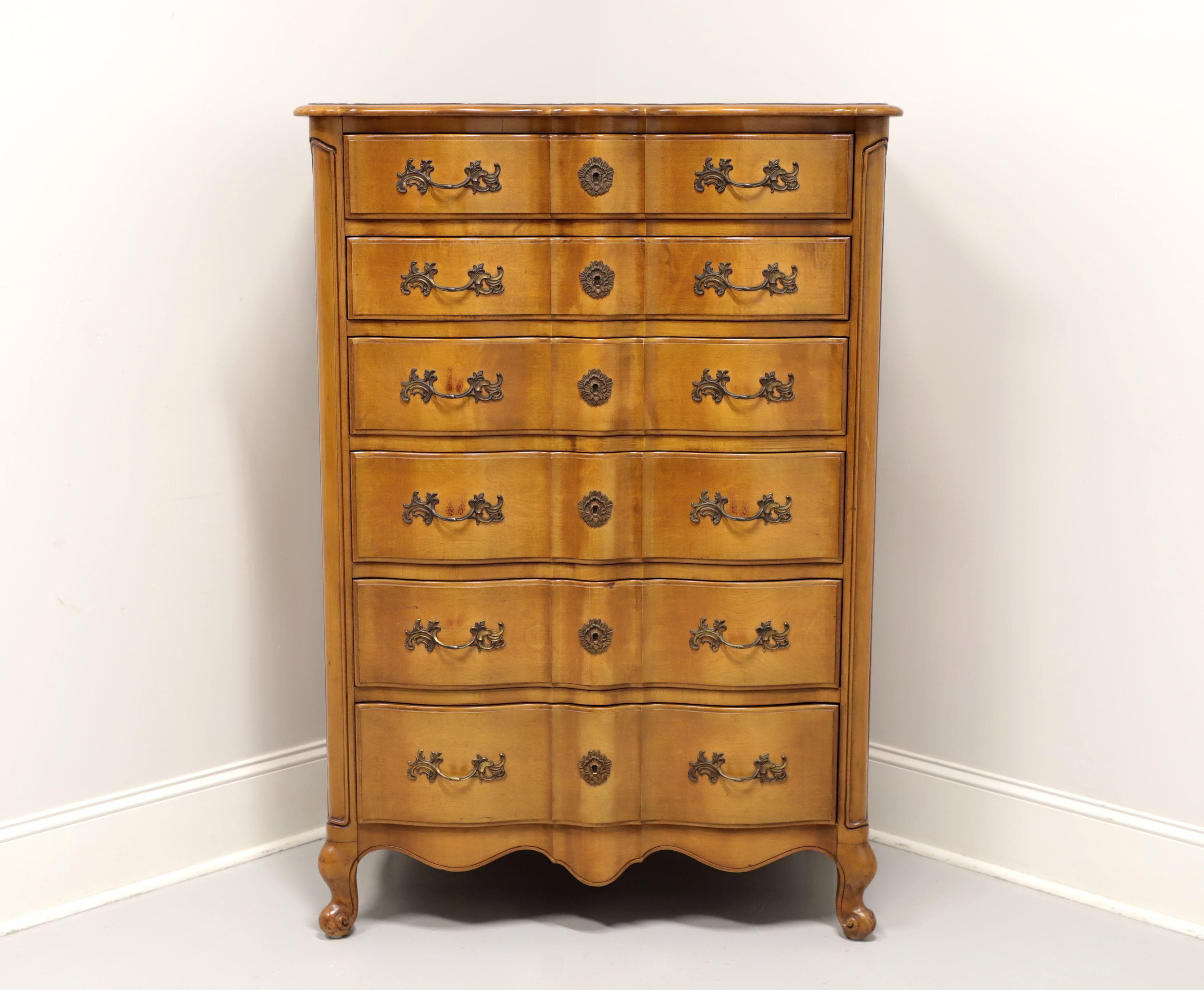 A French Provincial style chest of drawers by Flint & Horner, of New York, New York, USA. Solid maple, or similar hardwood, with decorative brass hardware, serpentine front and scroll front feet. Features six dovetail drawers with faux keyhole