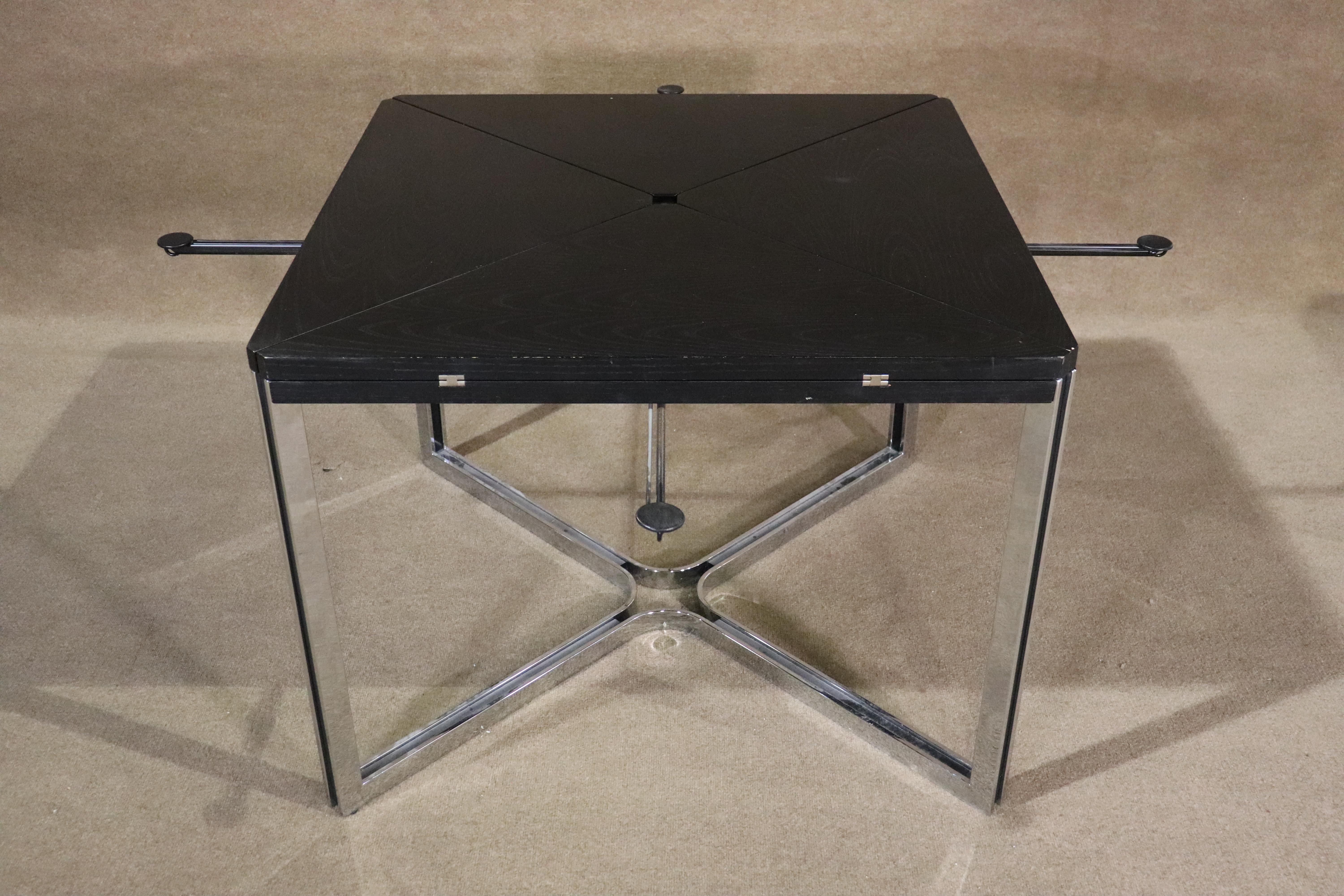 Modern style table with folding leaves and polished chrome base. Great style with 'X' shaped base and exposed hinges.
Width: 39.5-55.5 
Please confirm location NY or NJ.