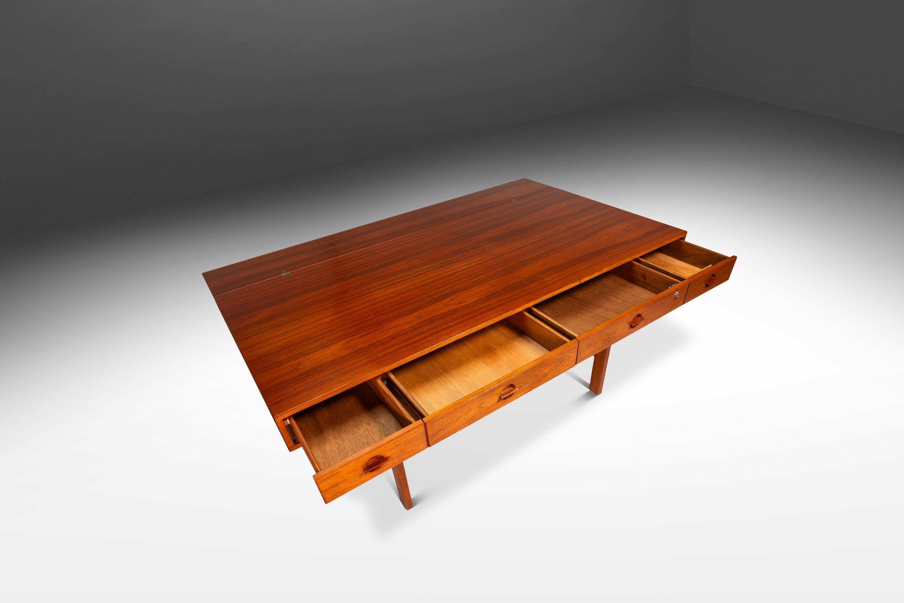 This sophisticated Danish Mid-Century Modern flip-top executive desk by Peter Løvig Nielsen, crafted in Denmark during the 1960s, exemplifies the era’s seamless blend of form and function. Constructed from rich teak, the desk showcases the wood’s