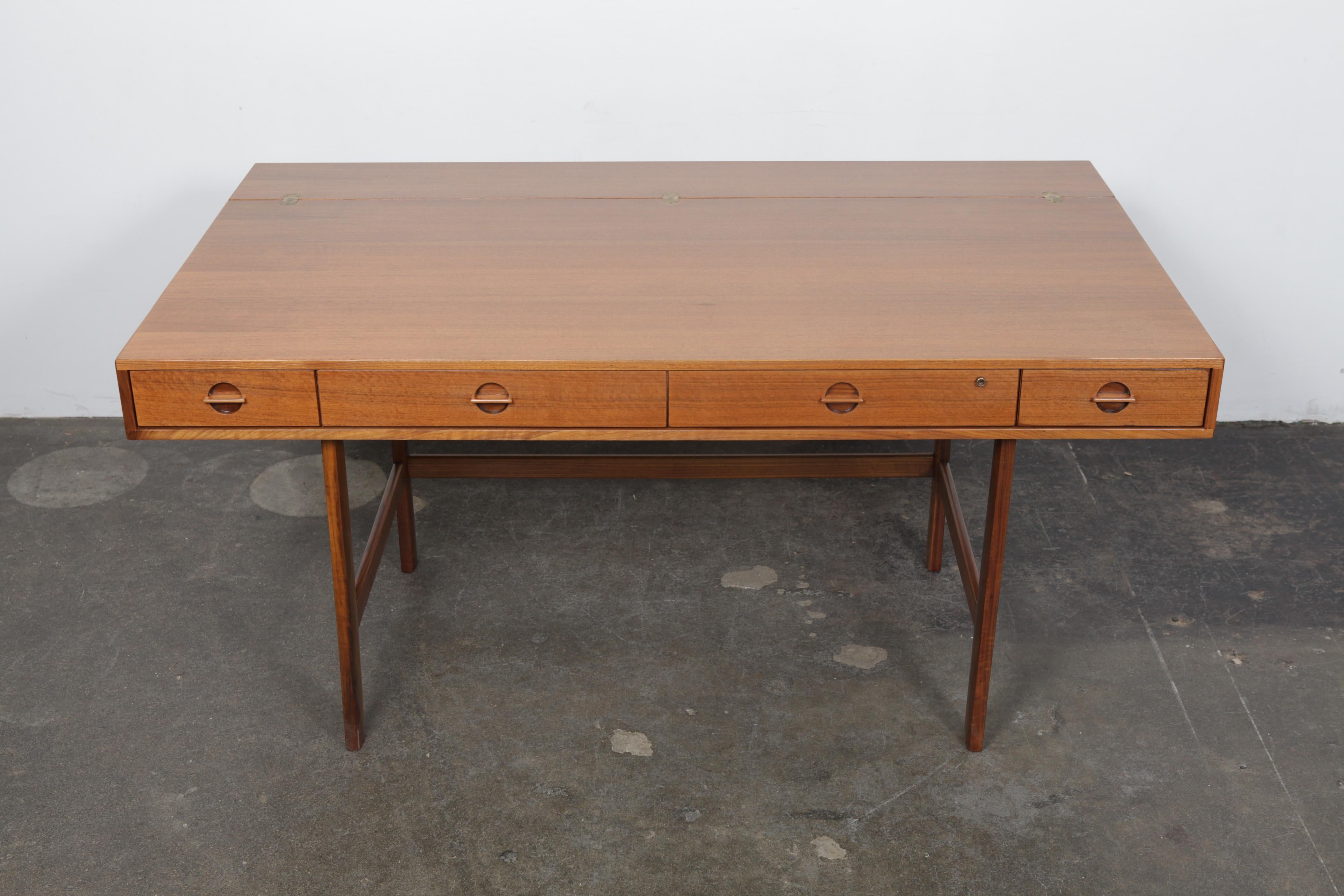 Walnut flip-top desk with ample storage and offering a stunning Silhouette. Newly refinished in a satin lacquer. Designed by Jens Quistgaard for Peter Løvig, Denmark, 1960s. This desk has been fully stripped, sanded and newly refinished in a satin