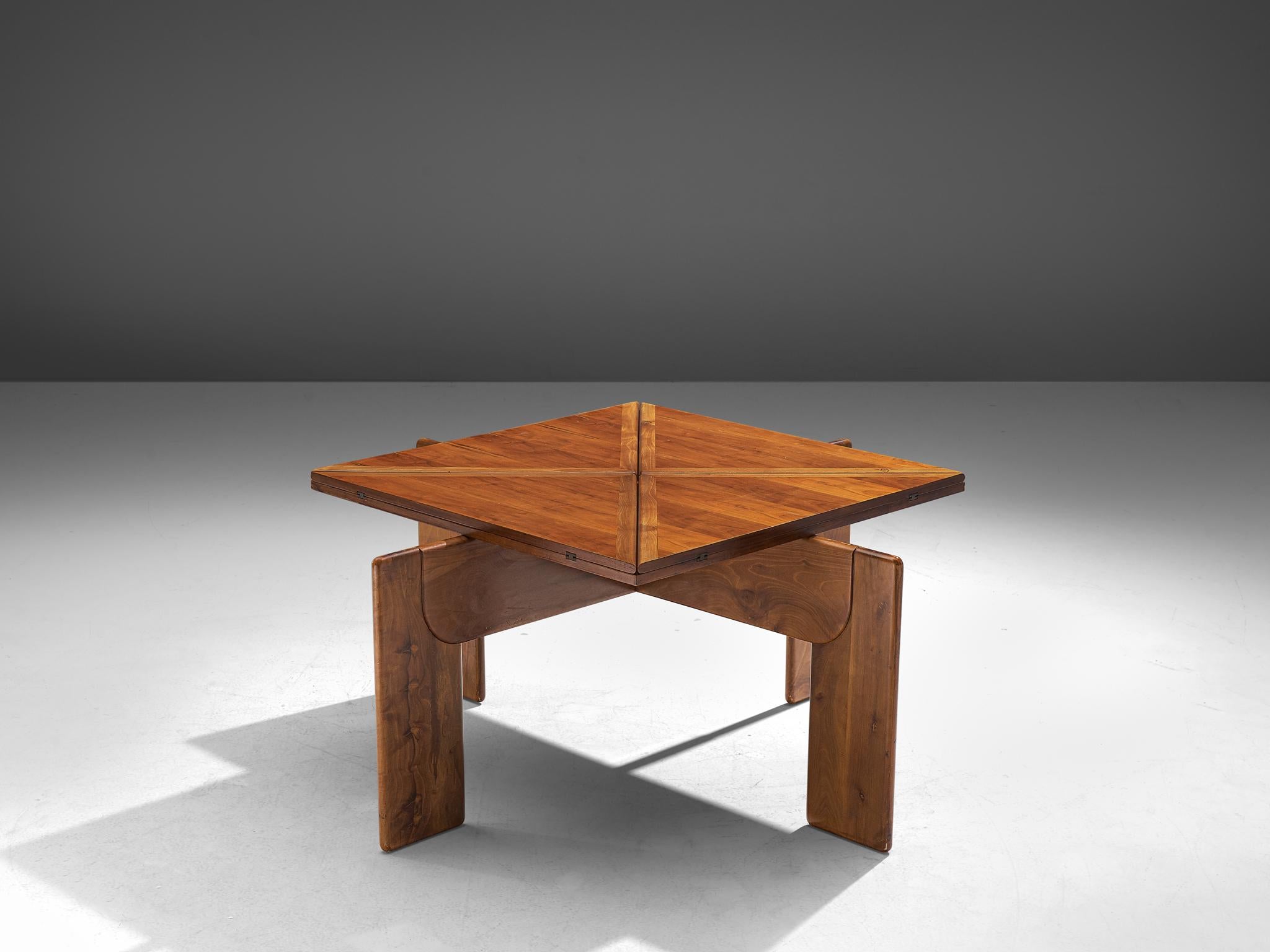 Extendable dining table, walnut and brass, Italy, 1970s.

Stunning square shaped dining table with a drop leaf table top. This dining table is manufactured in beautiful walnut wood, featuring striking, warm tones in the grain. The unfolded