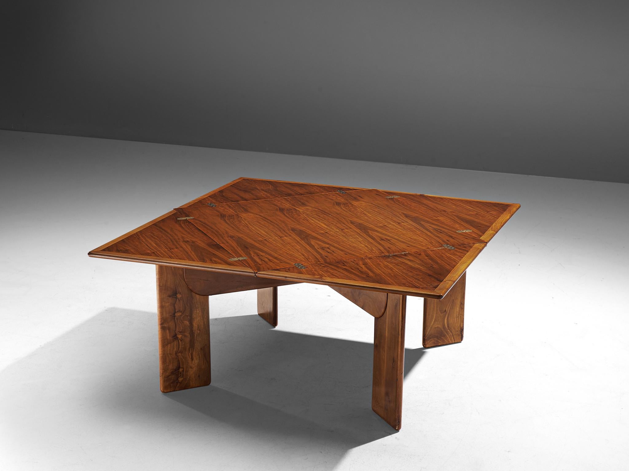 Silvio Coppola for Bernini, dining table, walnut, brass, Italy, 1960s. 

Stunning square shaped dining table with a flap tabletop. This dining table is made in beautiful walnut wood, featuring striking, warm tones in the grain. Therefore, the walnut