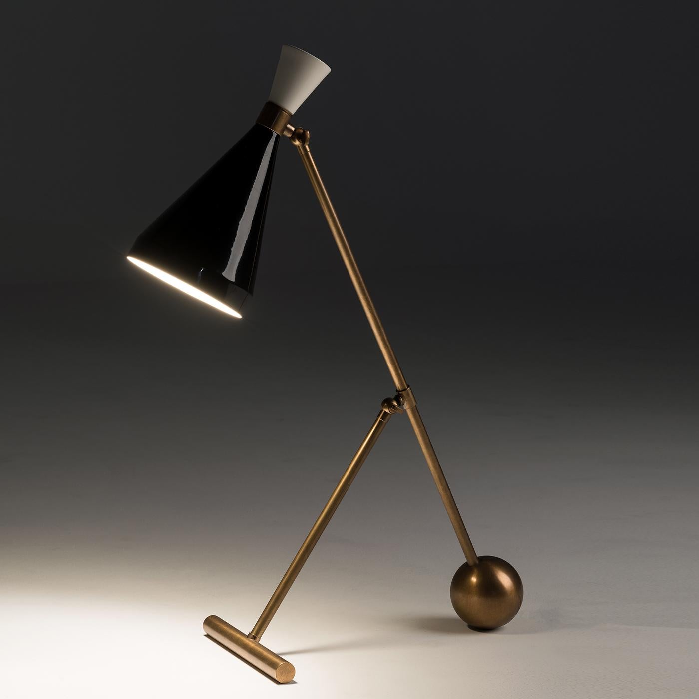 The flipper table lamp is characterized by simple lines for a modern allure. Supported by a burnished brass base, its conical shade is crafted from aluminium with a black lacquered finish. Perfect for desks and countertops too, this table lamp is