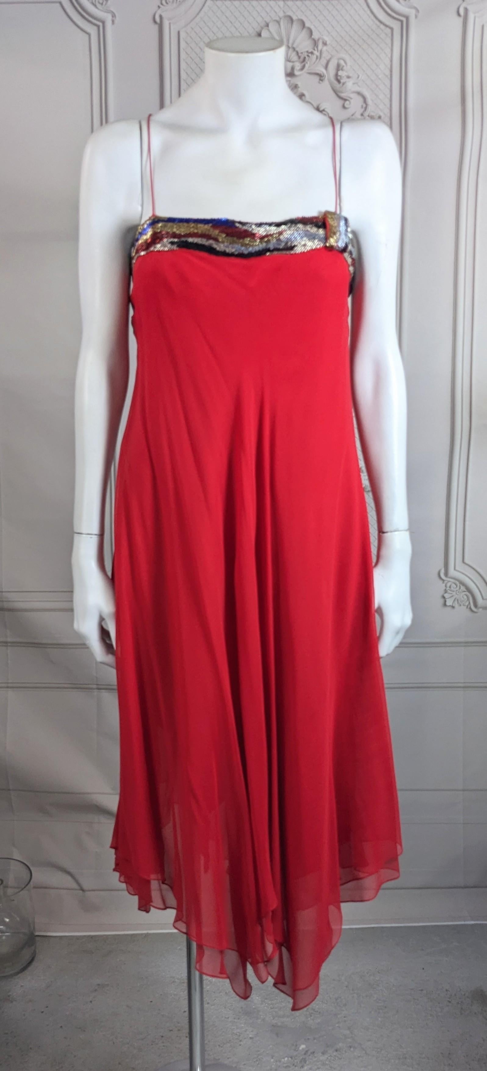 Charming Bias Silk Chiffon Beaded Dance Dress from the 1980's. Retailed by Mary Jane Denzer, a well known NY retailer who specialized in designer gowns, but who was also known to remove those labels. 
Flirty 2 layer bias cut red silk chiffon with