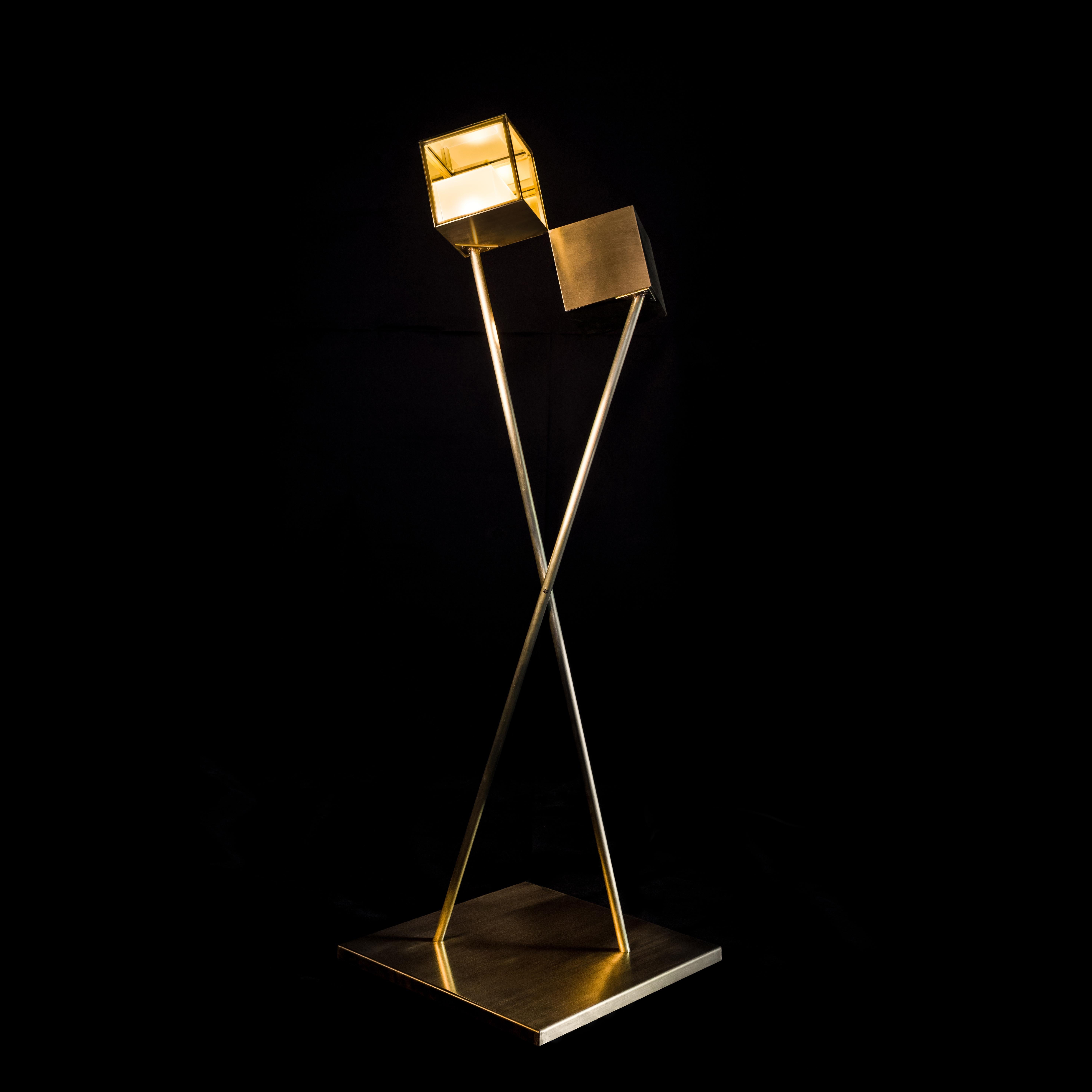 Flis is a sculptural floor lamp, a dynamic composition of two floating cubes. Each viewpoint unveils a different silhouette, a playful act between two elements reaching at their vertices, occasionally converging into a unity. 

When lit, the two