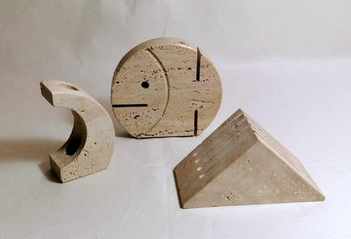 Desk set in Tuscan travertine Brutalist style; the set consists of a fish-shaped ticket holder, a rounded pen holder, and a triangular envelope holder; they were designed and produced between 1970 and 1973 by F.lli Mannelli di Rapolano