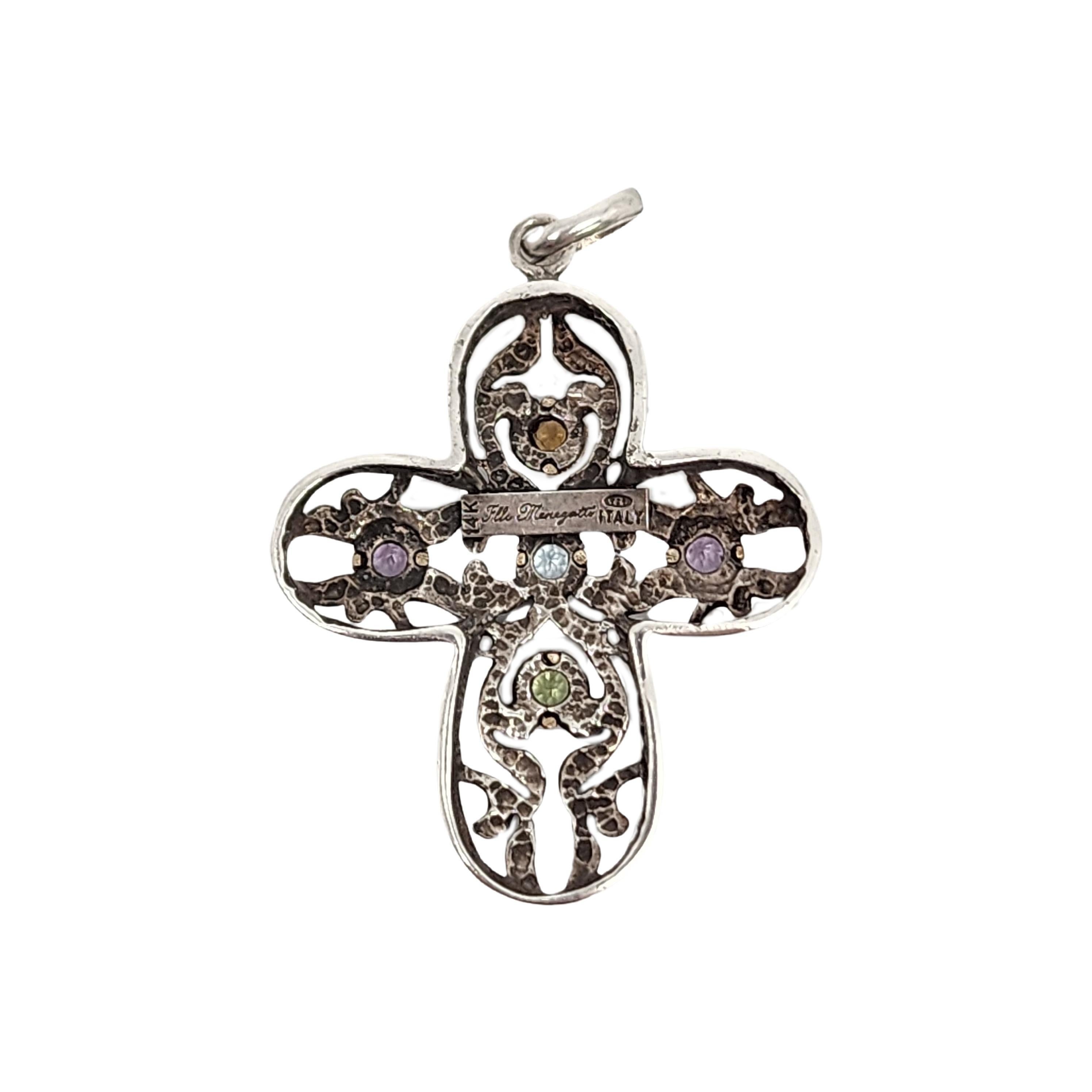 Sterling silver 14Kopen work cross pendant by Flli Menegatti.

Beautiful open work sterling silver cross with yellow gold bezel accents around gemstones that appear to be citrine, amethyst, blue topaz and peridot.

Measures approx 1 7/8