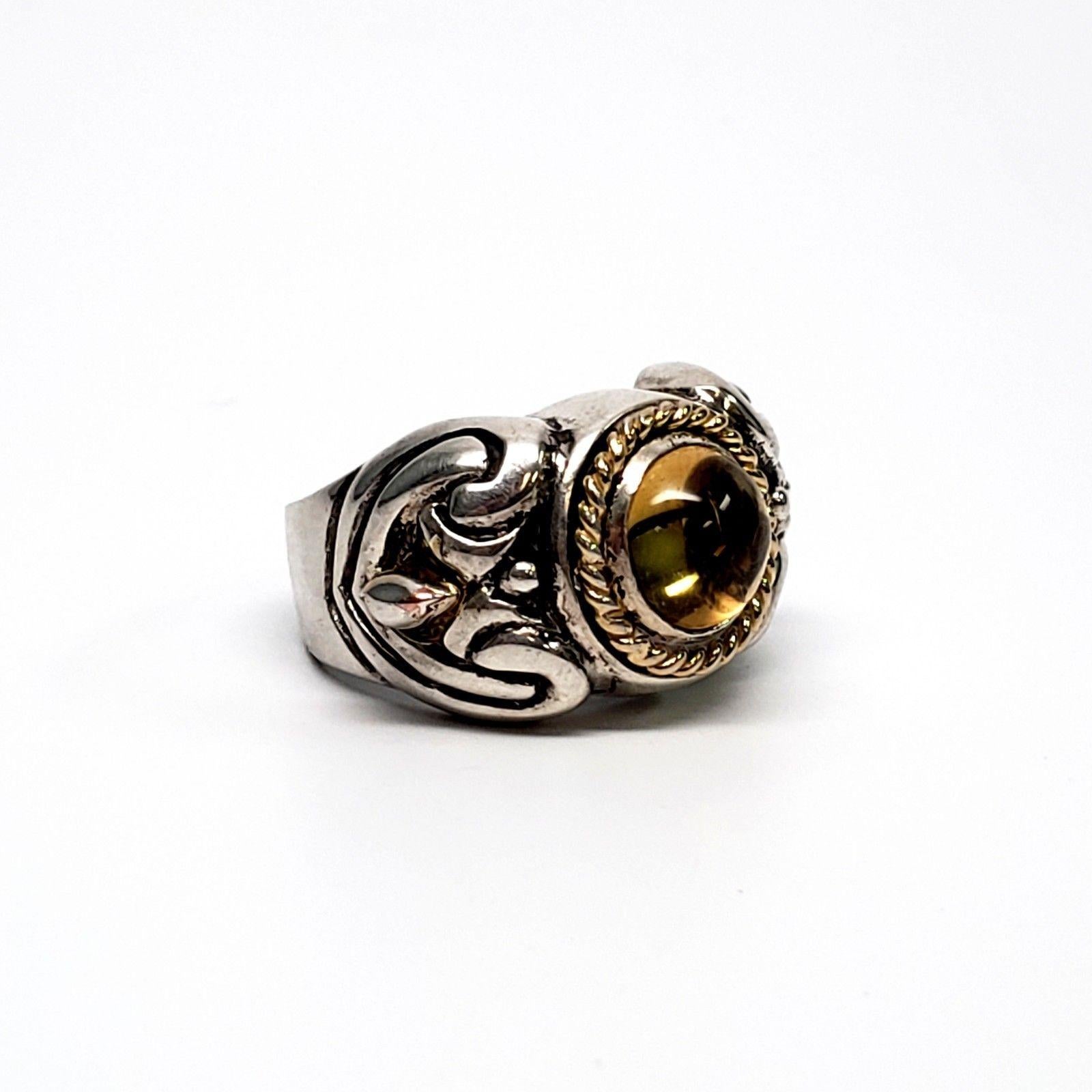 Flli Menegatti sterling silver/yellow gold accent citrine ring. Ring features a round citrine cabochon in a sterling silver setting with an oxidized design, yellow gold rope accent and a yellow gold teardrop on each shoulder.

Citrine cabochon