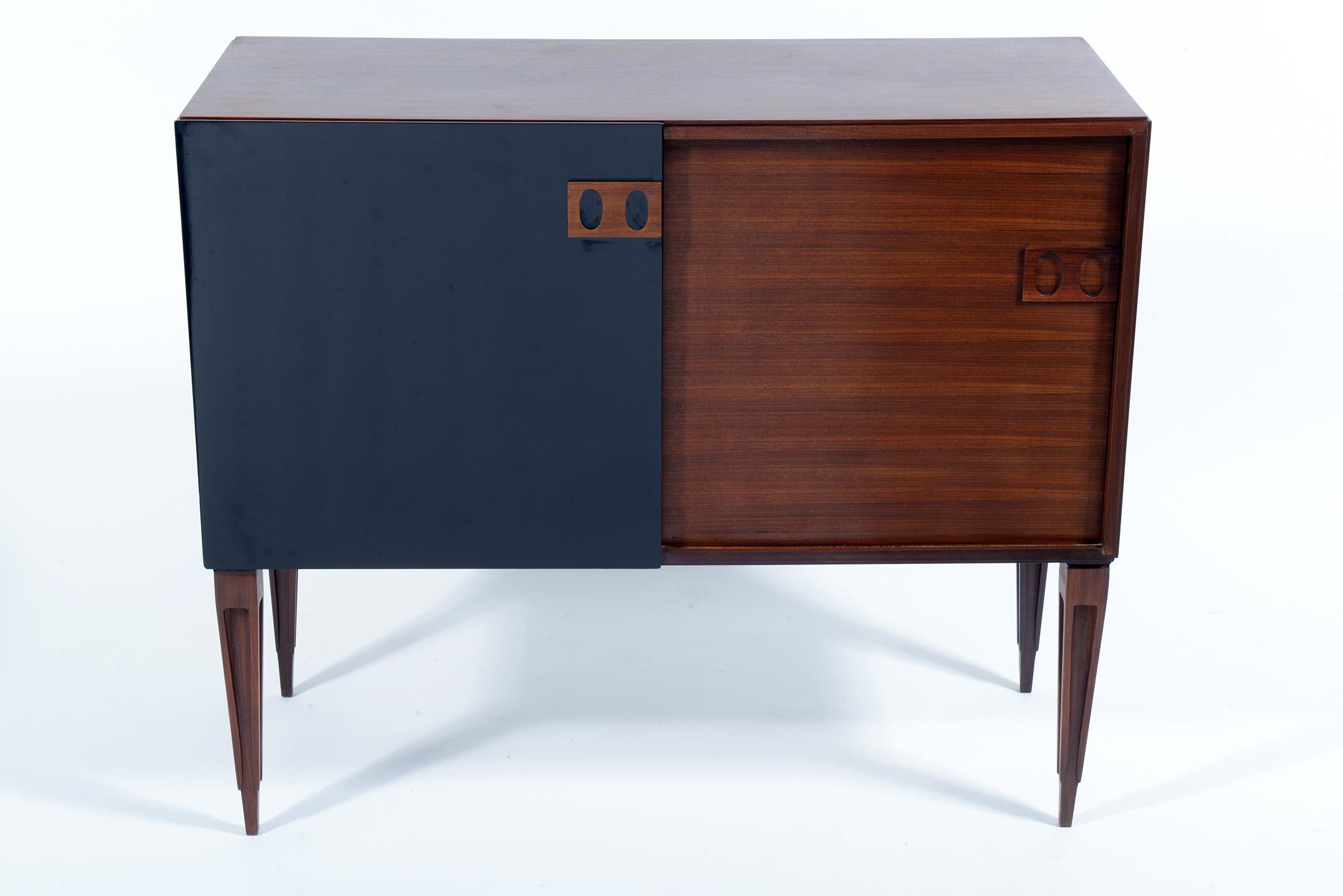 High quality of construction.
Teak wood structures and black lacquered doors.
Signed with Fire Mark by F.lli Proserpio, circa 1960.
Two sliding doors each cabinet with teak shelve inside.
Solid teak sculptured stylish legs.
The cabinet is finished