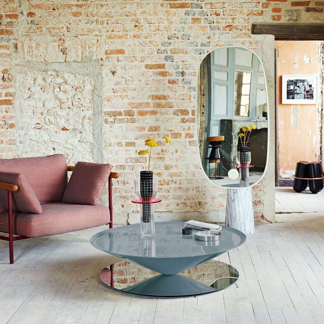 Float is a sculptural coffee table that challenges senses and perception. A massive metal cone apparently floats above a mirror polished steel base.The geometrical design is softened by refined details such as the bezelled lip on the edges of the