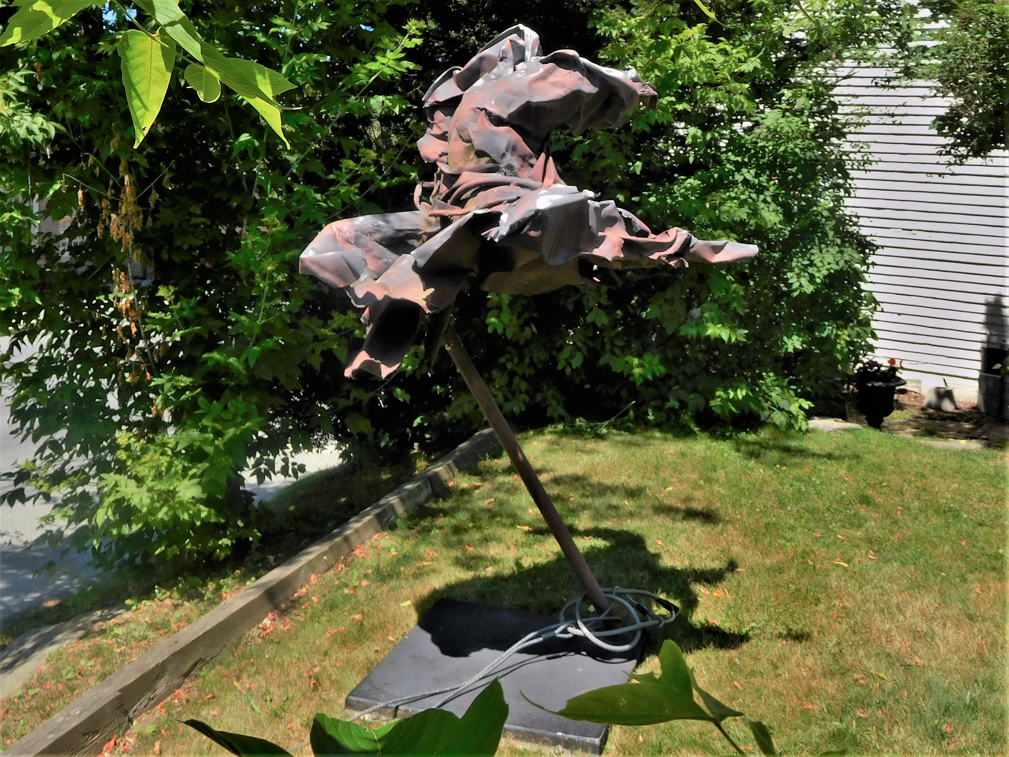 Judith Brown (1931-1992), dancer and multifaceted artist and sculptor, who had studios in New York City and Reading, Vermont, created this monumental sculpture from junked and crushed automobile parts. It is a Postmodern Expressionist figure from a
