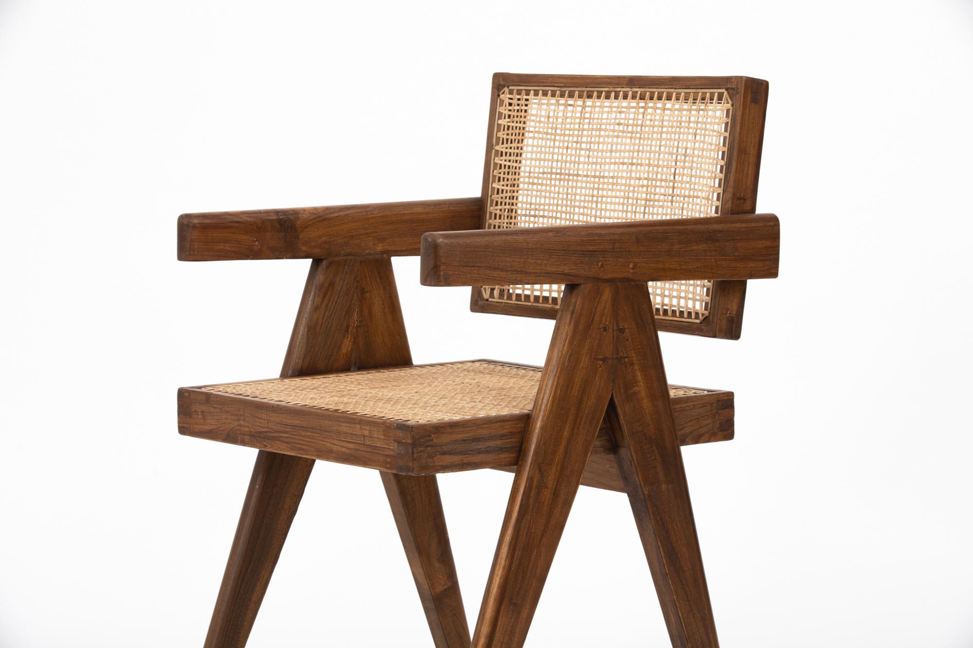Designed by Pierre Jeanneret, this original teak and wicker floating back armchair with cushions was made for the famous Modernist capital city of Chandigarh, India, which was designed under the direction of Le Corbusier, Jeanneret, and their team.