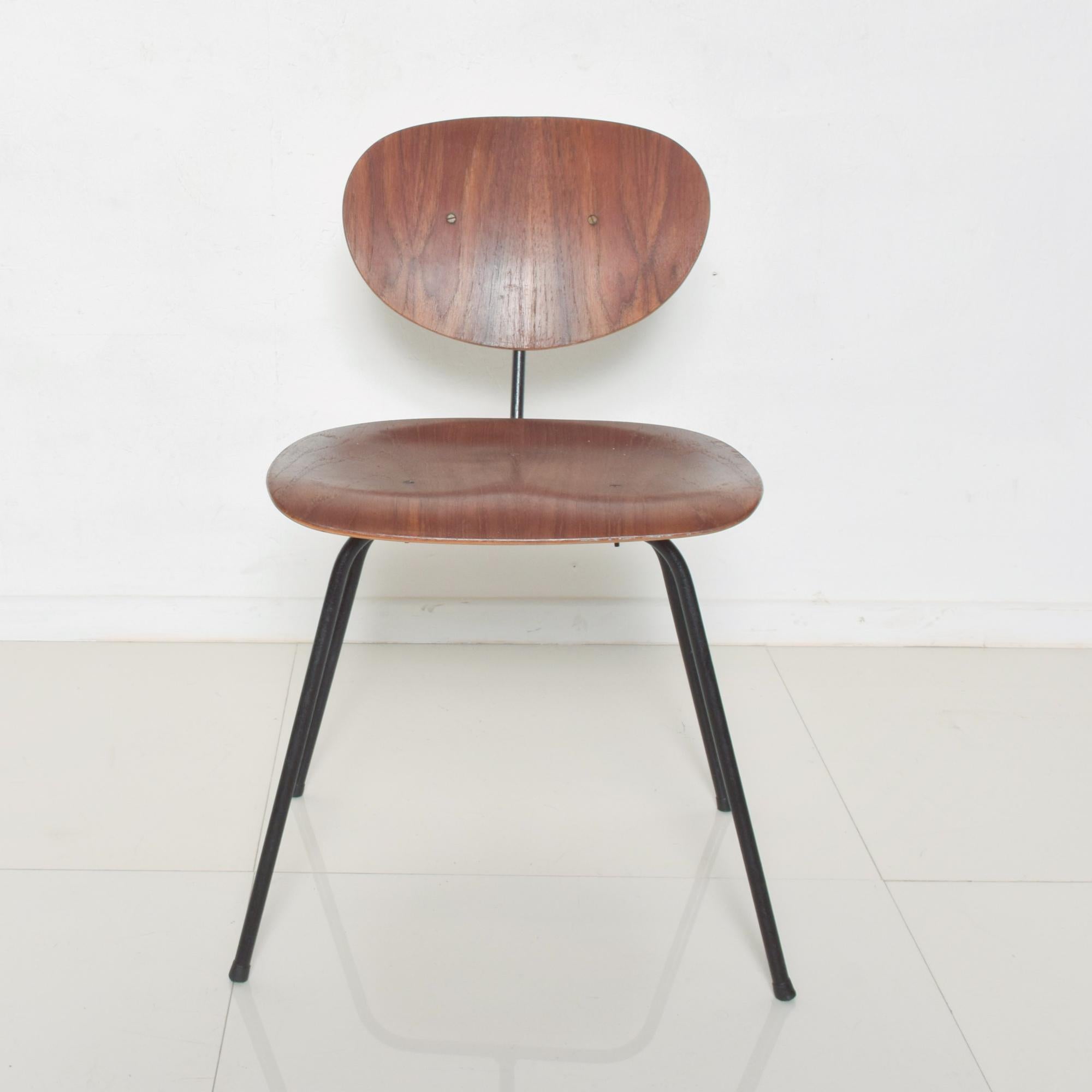 AMBIANIC presents
Late 1950s Molded Chair after Eames for Herman Miller 
marvelous midcentury chair
Sculptural black Iron base
Features Molded wood seat and back rest.
No label, chair appears as a prototype.
27 .25 H x 26.25 W x 22.75 D, Seat 17.25