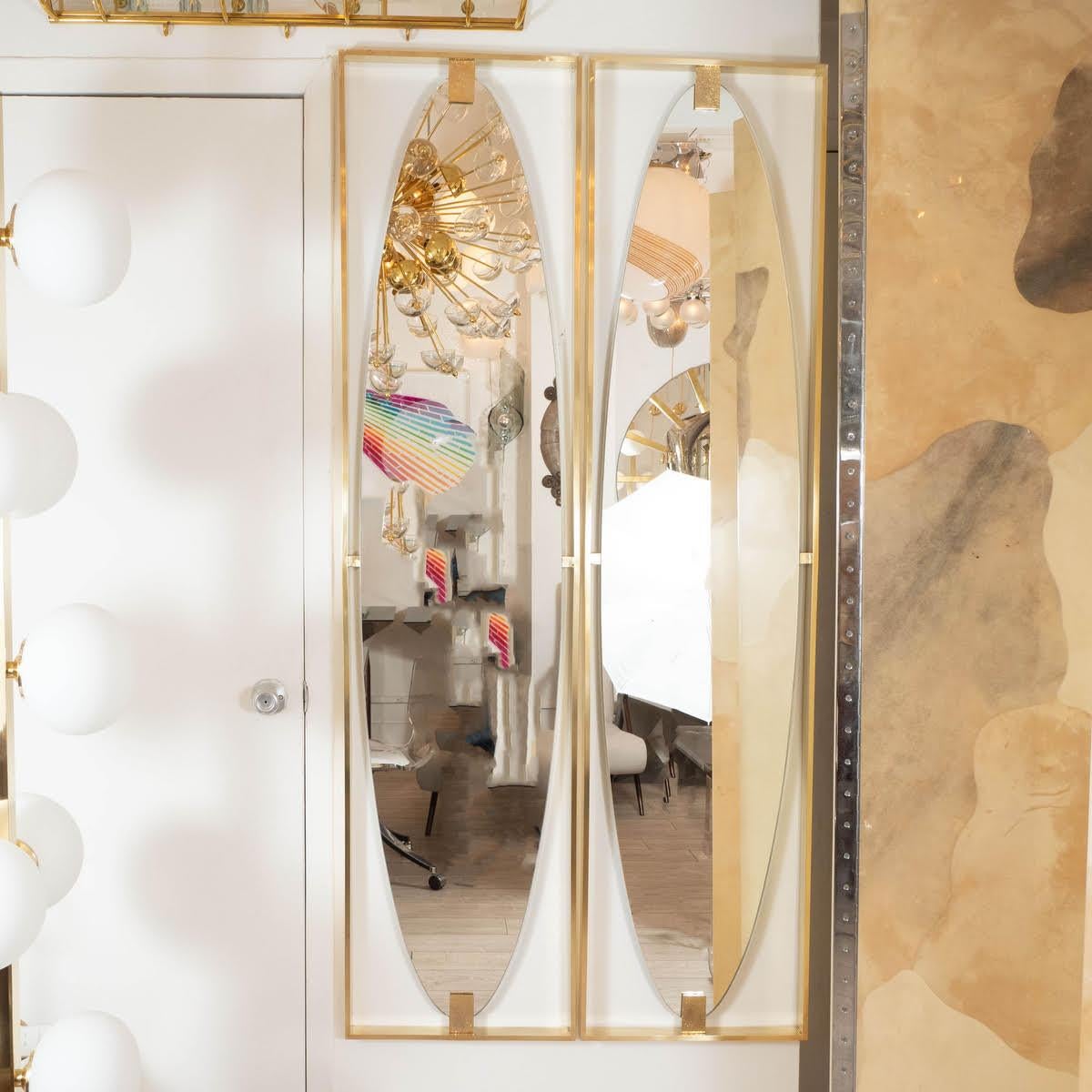 Floating brass surround mirror with embossed clip details.