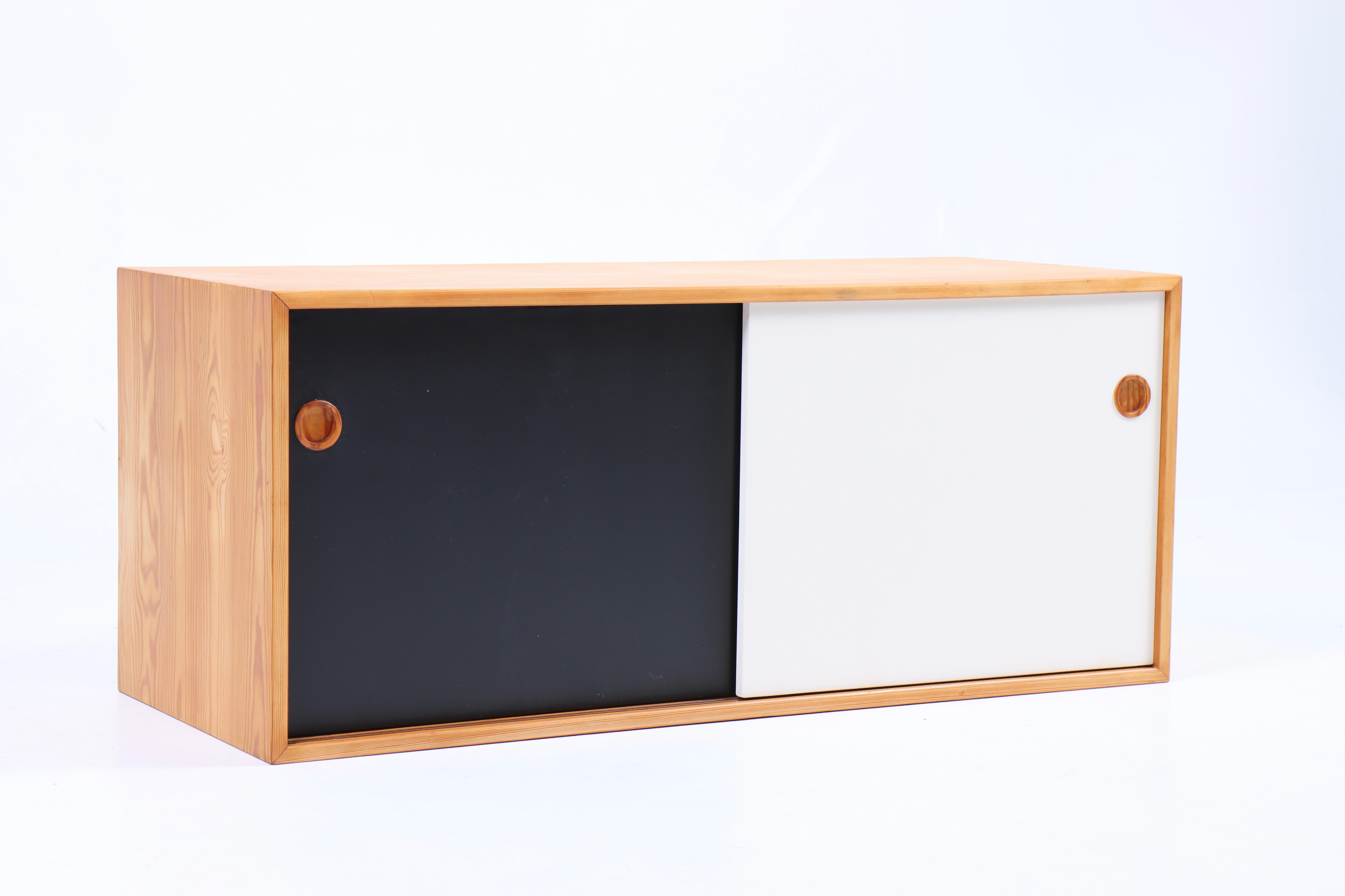 Wall mounted cabinet in pine with colored panels. Designed and made in Denmark 1950s.