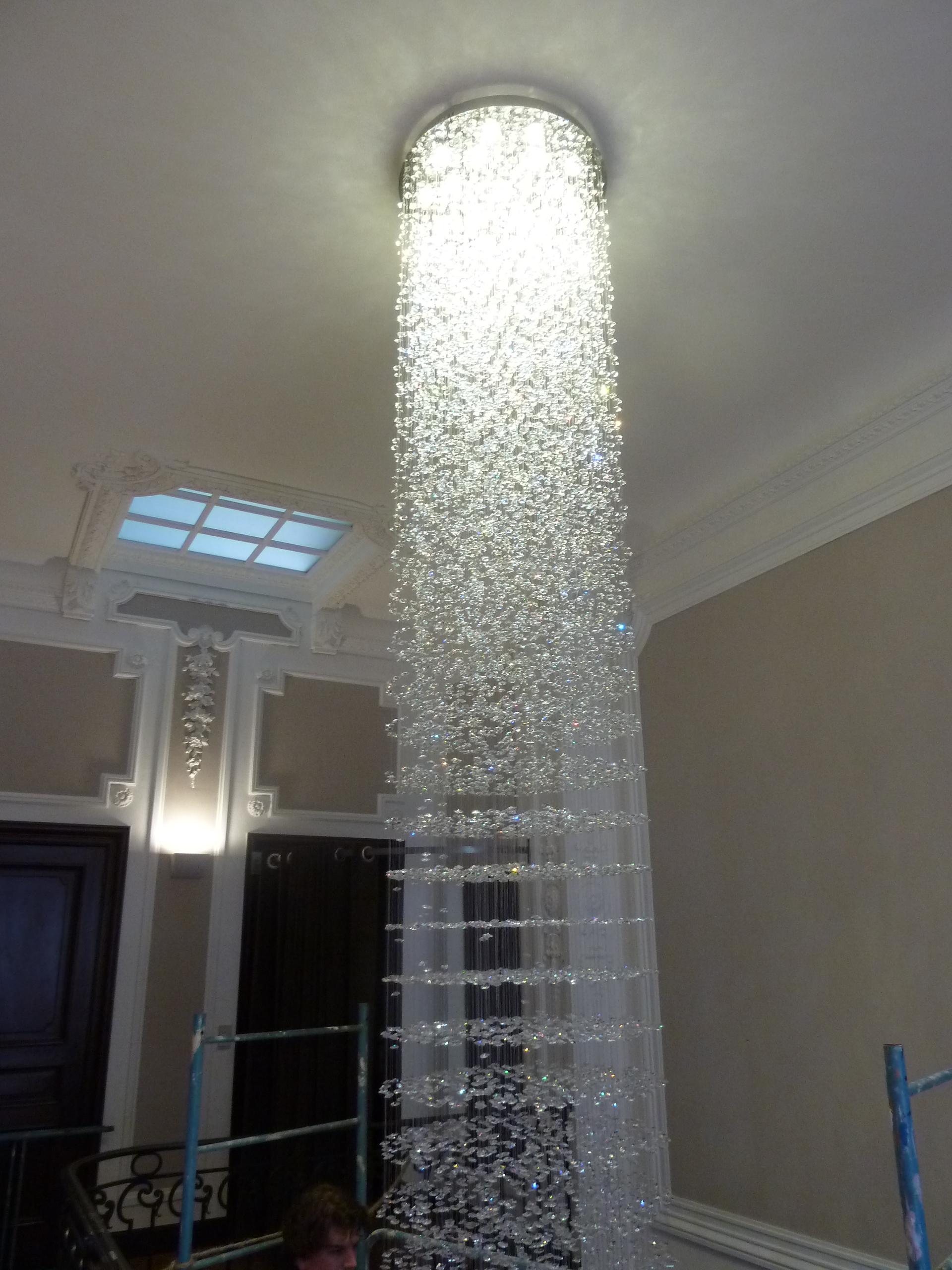 This is a floating crystal chandelier made with Swarovski Crystal. The chandelier is made from transparent wires with hand-woven Swarovski crystal balls (different shapes are possible). The chandelier in the pictures in custom-made for a 15 meters