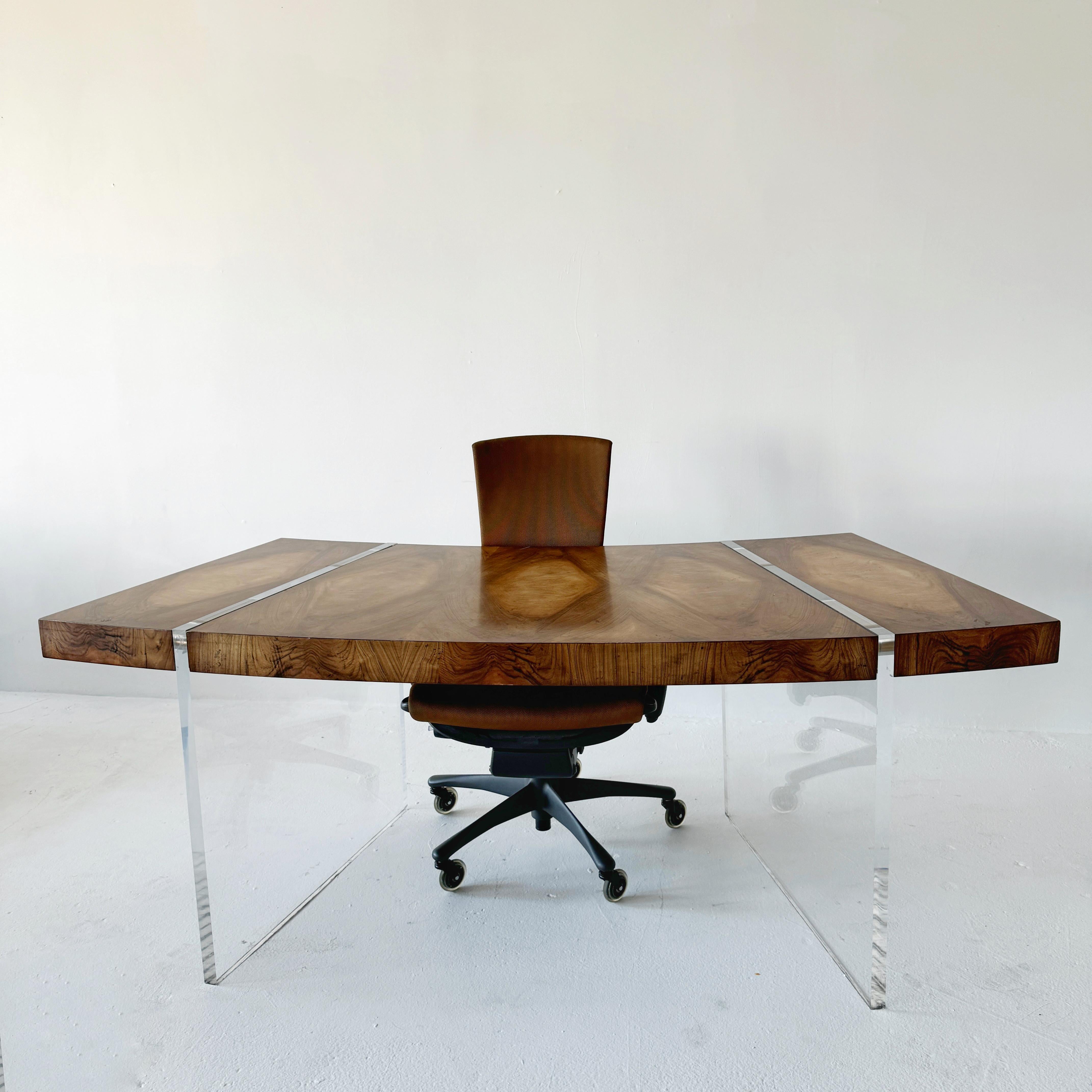 extraordinary curved cerejeira grain desk with one drawer and lucite legs, gives the illusion of floating.

This remarkable desk features a beautifully curved cerejeira wood grain surface, offering a rich, natural texture with striking visual depth.