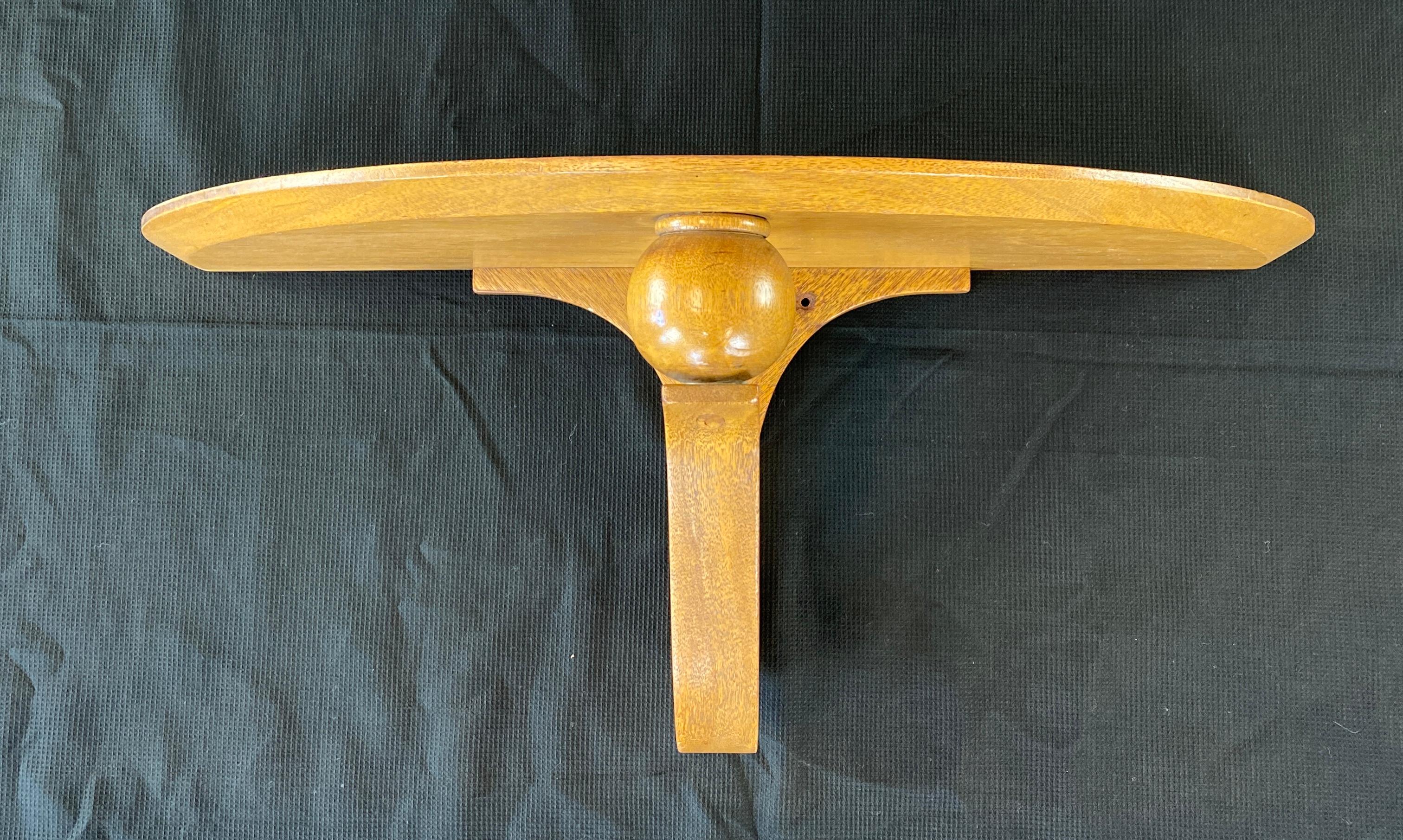 A floating demilune wall shelf by Edward Wormley for Dunbar circa 1950s.
Not sure of the type of wood, thinking it's fruitwood or pecan.