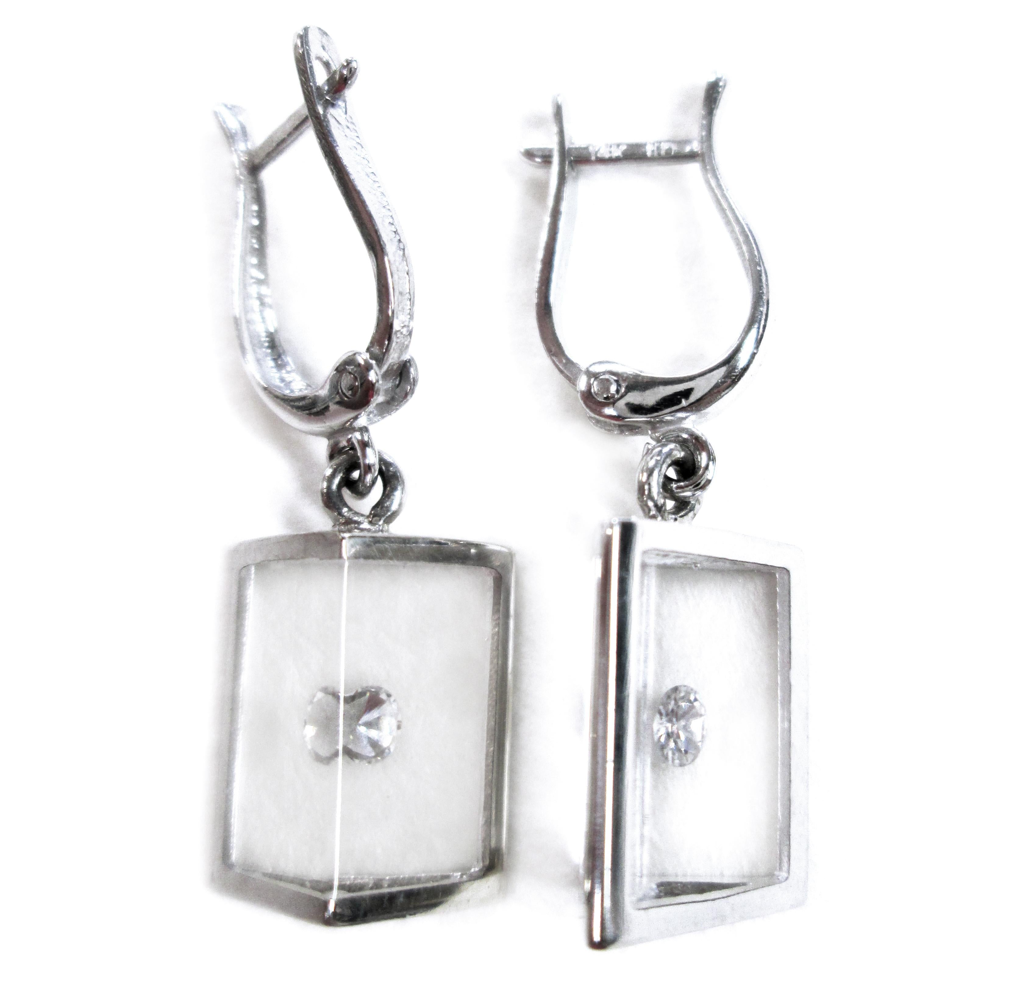Incogem Floating Diamond Pyramid Earrings: 14k White Gold. The pendant is handcrafted of recycled 14k white gold. A single brilliant-cut diamond in each earring with the reflection creating an optical illusion of multiple diamonds. 0.16ctw. The