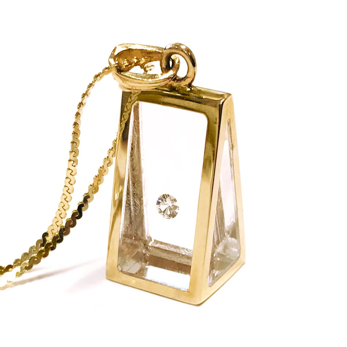 Incogem Floating Diamond Pyramid Pendant: 14k Yellow Gold. The pendant is handcrafted of recycled 14k yellow gold. The diamond is a brilliant-cut, 58 facets, VS1 in clarity (G.I.A.), and H in color (G.I.A.). The diamond weighs 0.12 carat and floats
