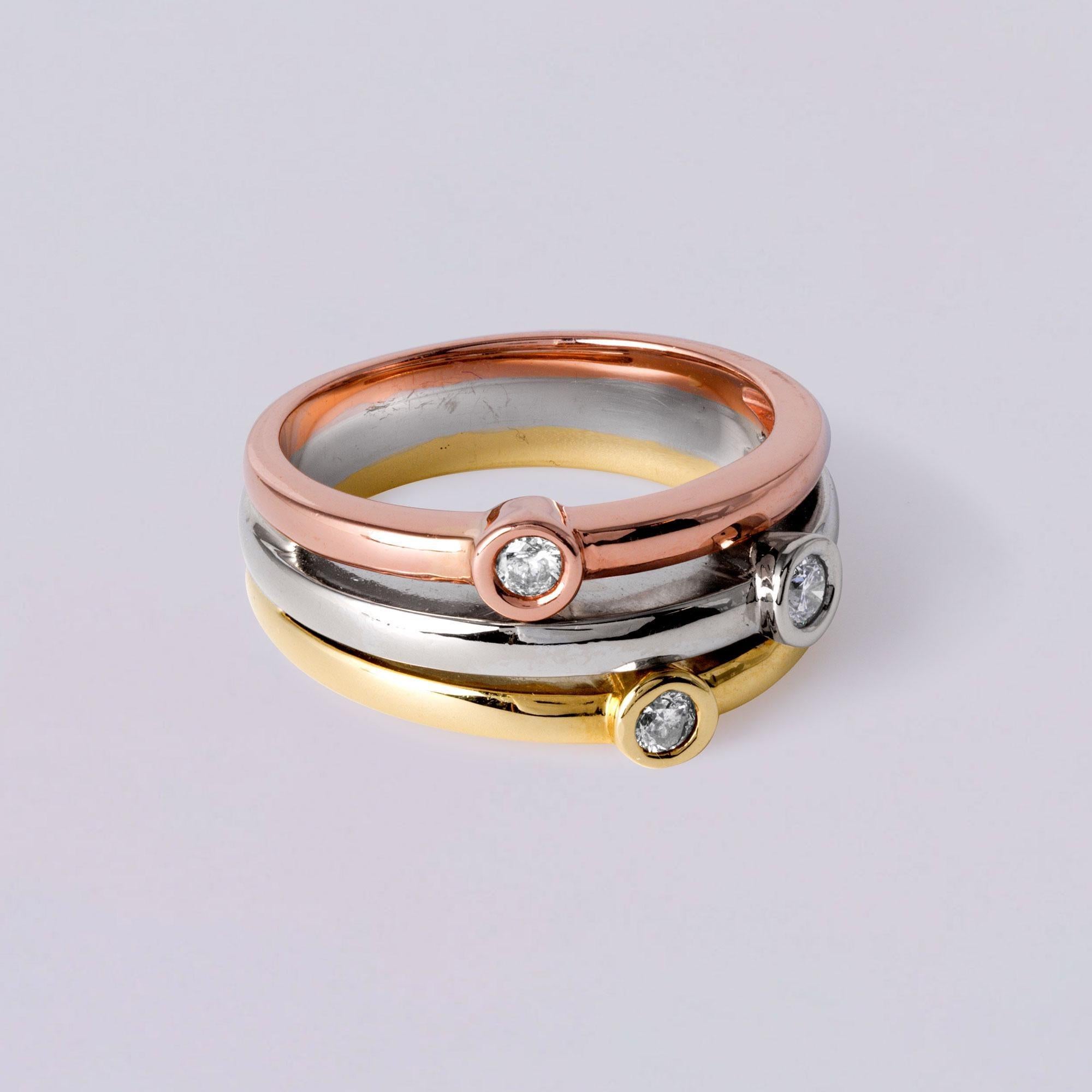 This is a lovely and elegant tri gold color ring featuring a unique free-form design and three bezel-set round brilliant diamonds. Each band is crafted at a different height, giving this piece a stylish, layered look.

Material: Solid 14k gold