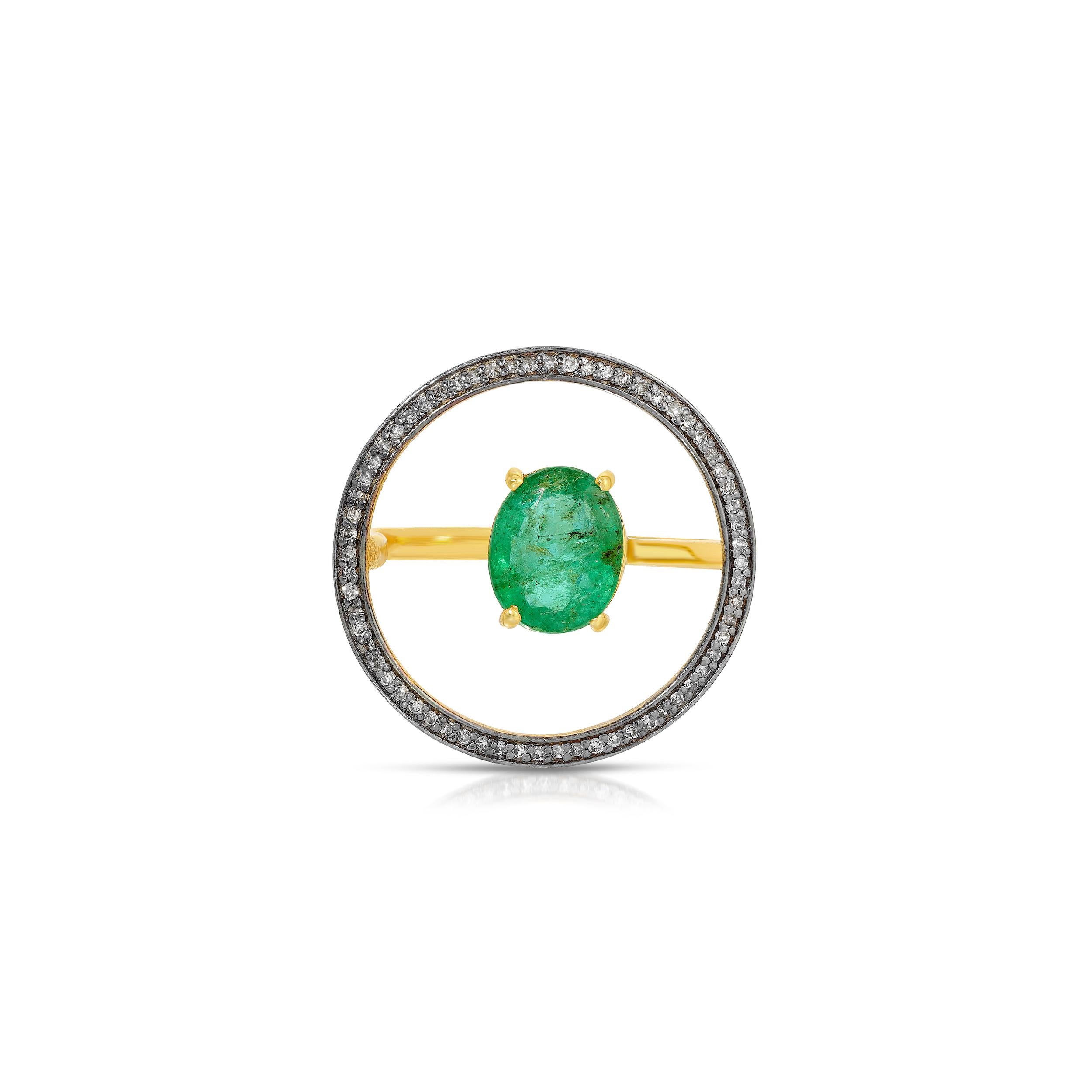 A fiery, oval cut 1.49 Carats Emerald in an unusual design which gives the illusion of the Emerald being suspended and set in a halo of .18 Carats of White Diamonds. The Emerald is set on a ring of 22 Karat Gold overlay Silver and the sparkling