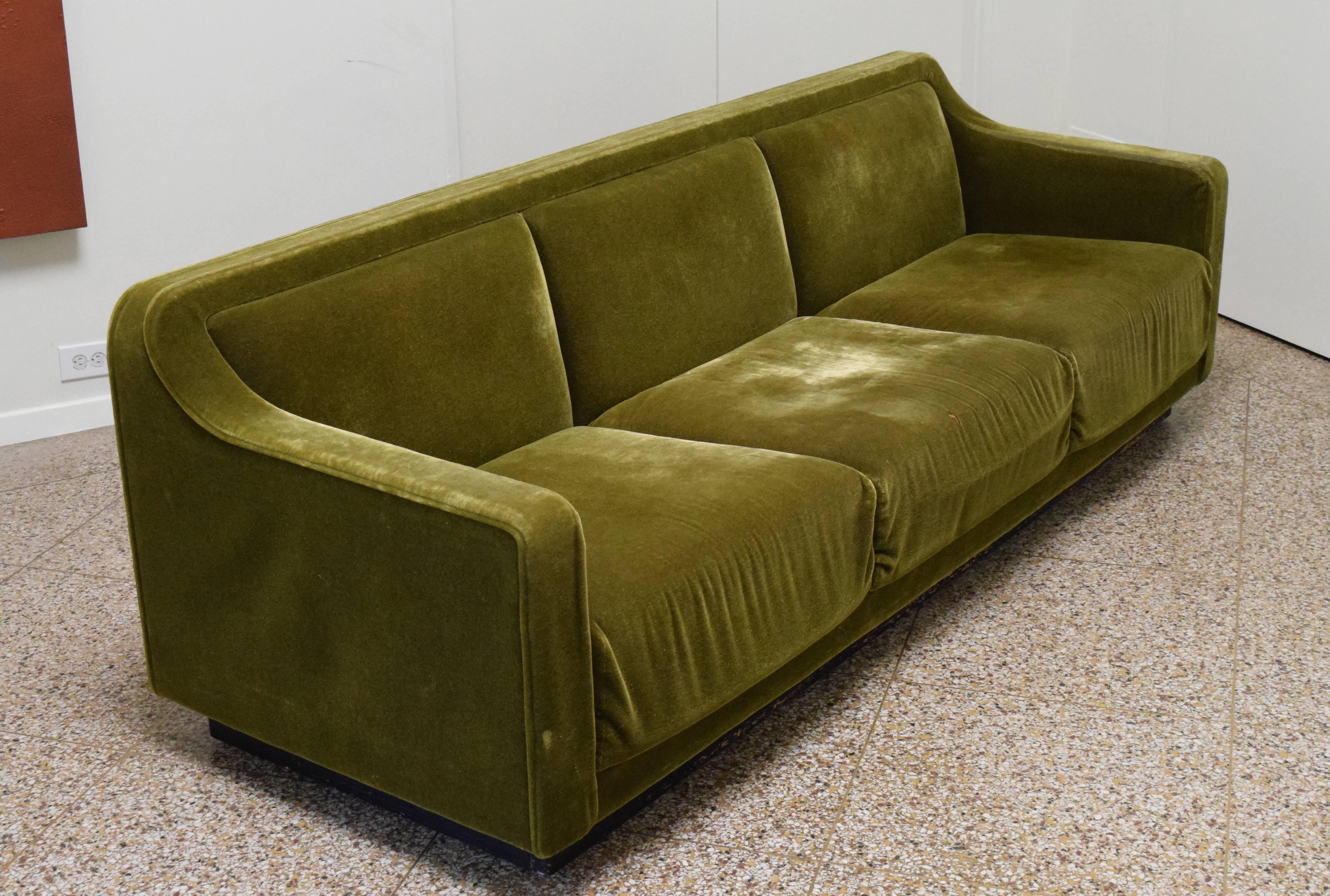 Dramatic vintage sofa from Lehigh-Leopold, a furniture company who collaborated with noted 20th century designers such as Warren Platner and Ward Bennett. Exquisite form with sweeping, continuous armrests and elevated on a wood plinth base.