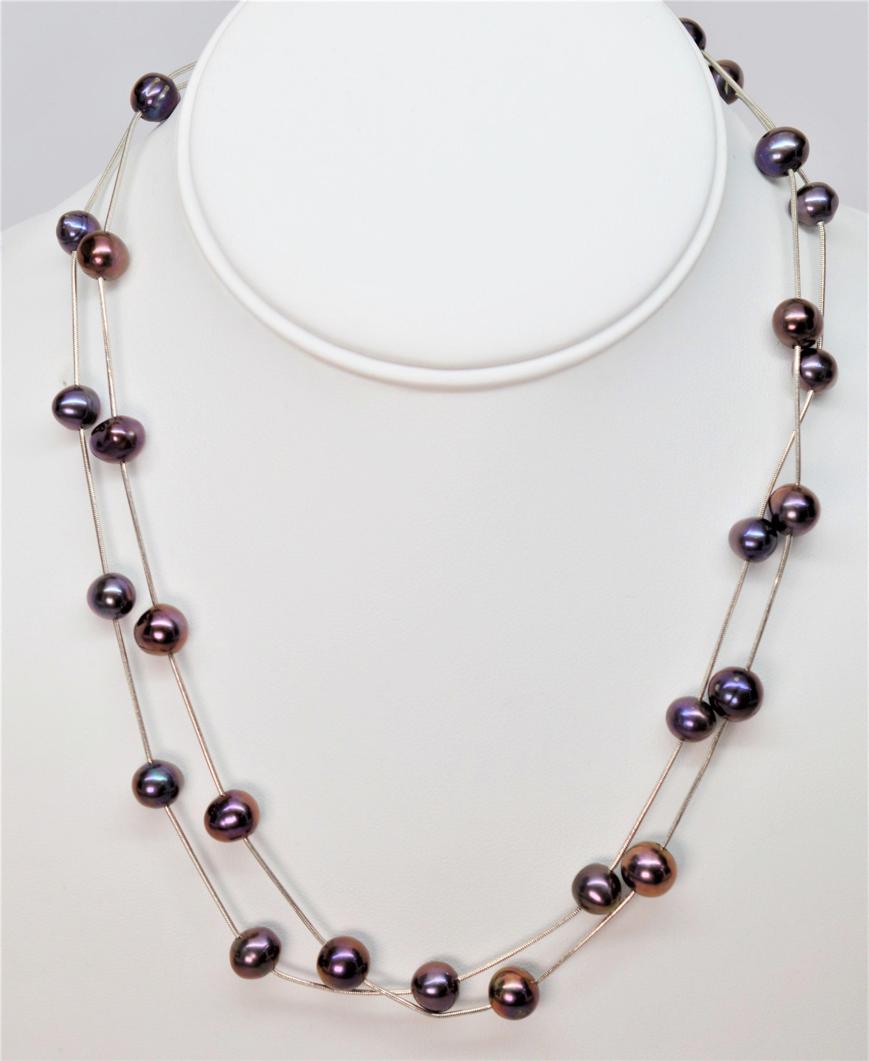 Floating on fourteen karat 14k white gold snake chain are vibrant iridescent natural shaped Akoya Pearls. Included are one set of two (2) seventeen inch strands of 
off-round to button shaped pearls ranging in size 7.5 - 9mm with a colorful