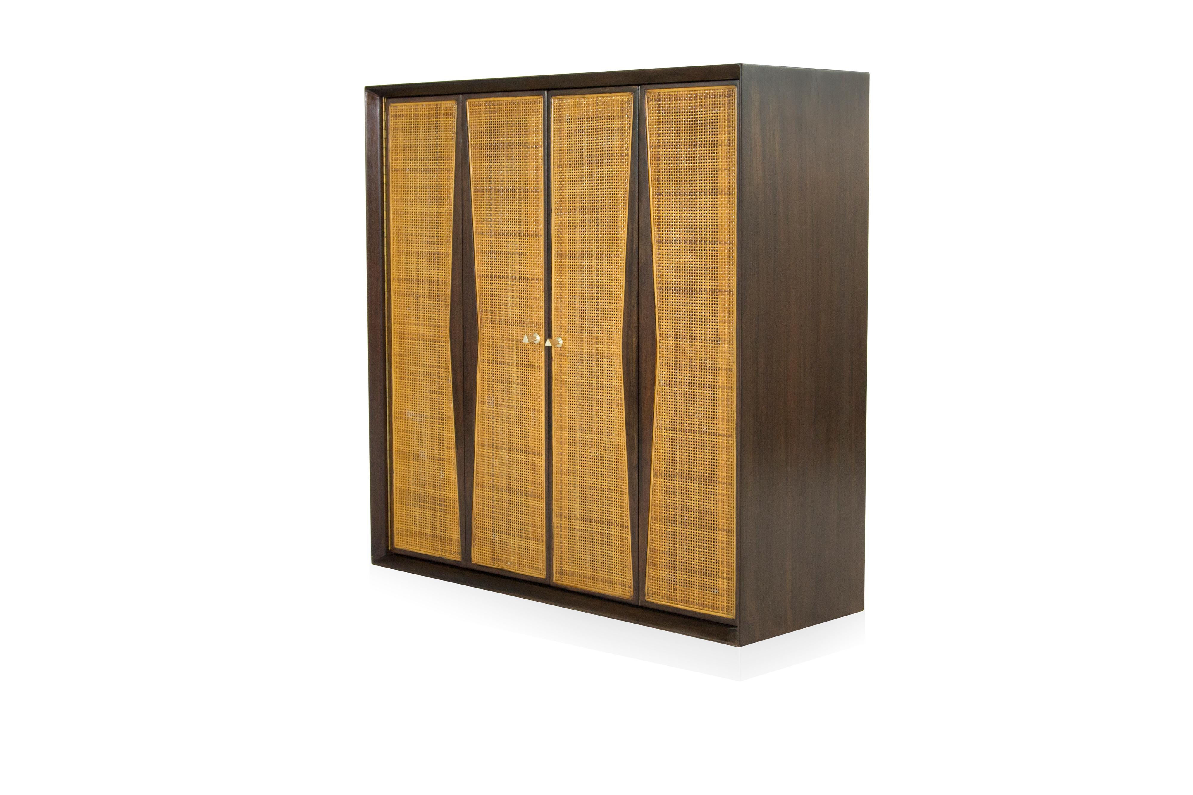 Extremely rare floating liquor cabinet designed by Vladimir Kagan for Grosfeld House, circa 1950s.

Walnut fully restored. Original caning in mint condition.