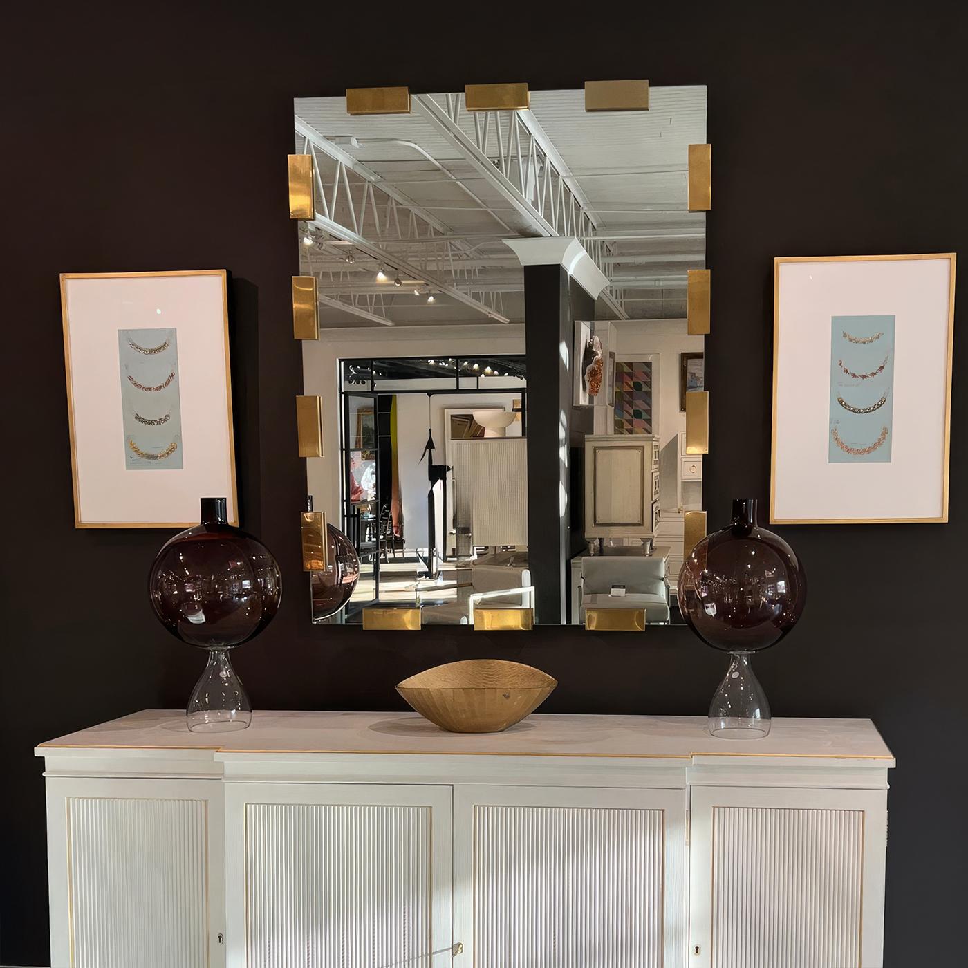 Designed to enhance both modern and classic interiors, this statement piece features clean mirror glass accentuated by satin brass lacquered plated finish mounts. The floating effect creates a sense of depth and refinement, making it a striking