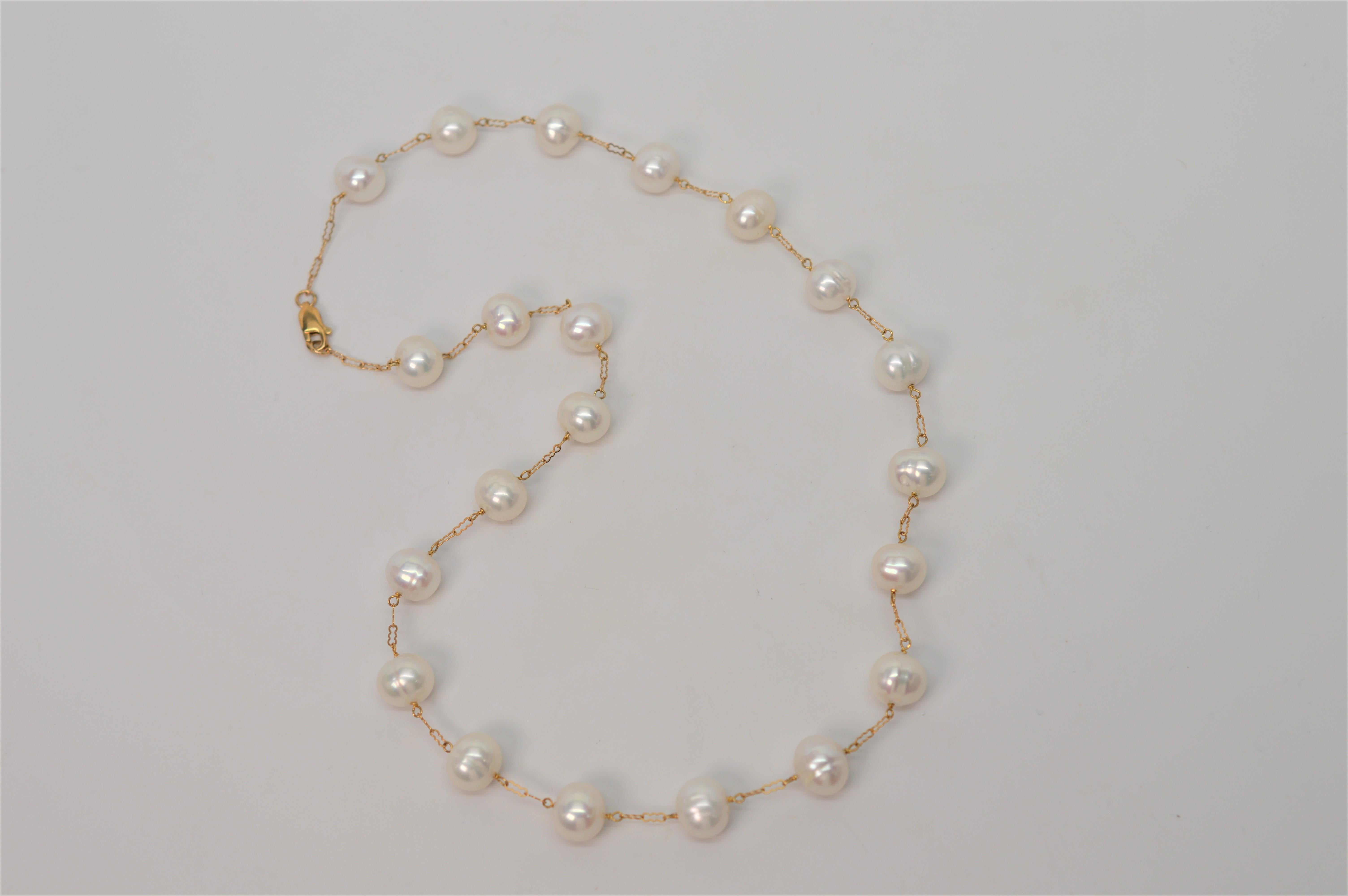 Nine millimeter naturally ringed White Akoya Pearls float on this attractive 14 Karat Yellow Gold Open Link Chain creating an elegant 20 inch necklace that is always fashionable and can complete any look from dress to jeans . Finished with a lobster