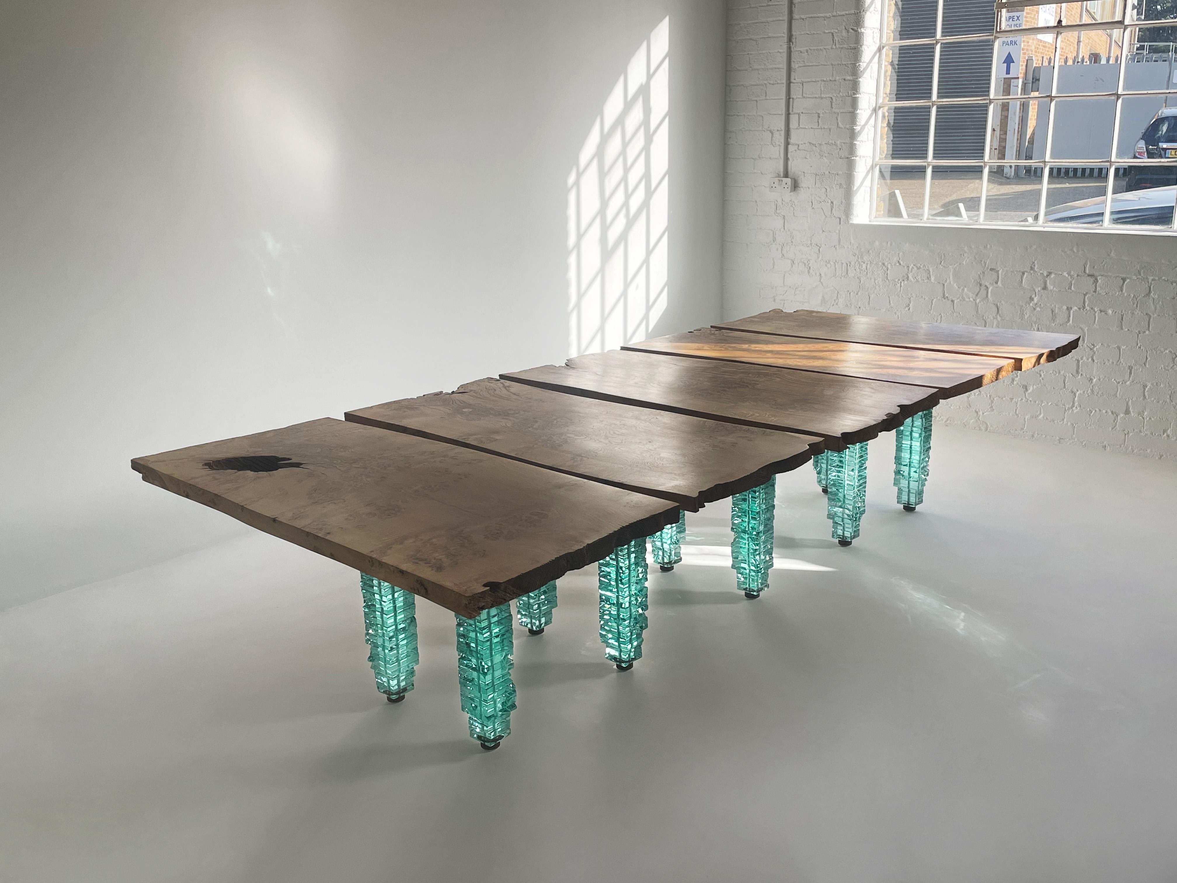 An absolutely spectacular dining / conference table by acclaimed glass and steel artist, Danny Lane. 

This unique table comprises five elements joined as one. Pre-tensioned glass towers support highly figured English Oak planks connected by