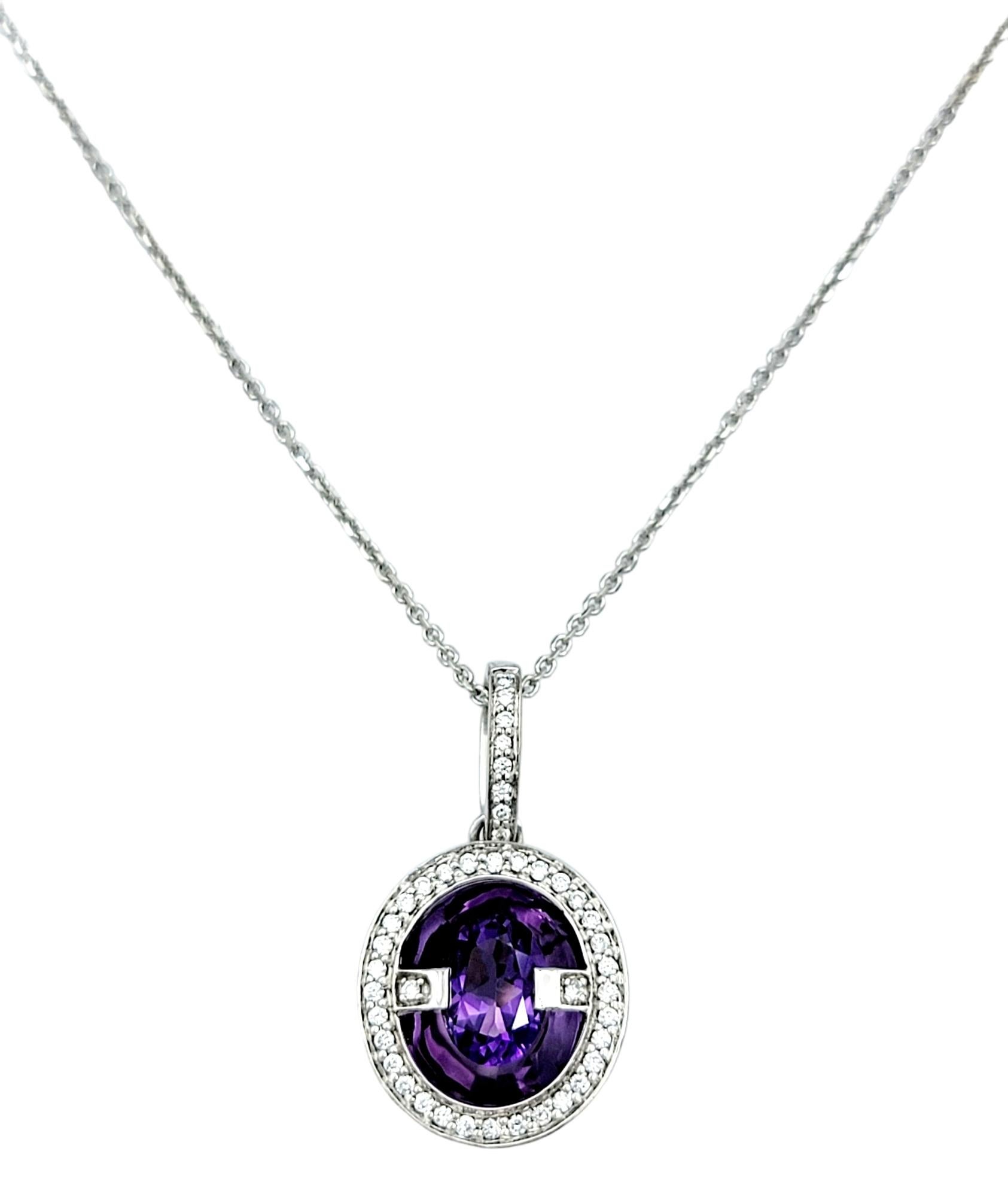 This exquisite oval amethyst and diamond pendant, delicately set in 14 karat white gold, exudes elegance and grace. The oval amethyst appears to float at the center of the pendant, surrounded by a halo of sparkling diamonds that add a touch of