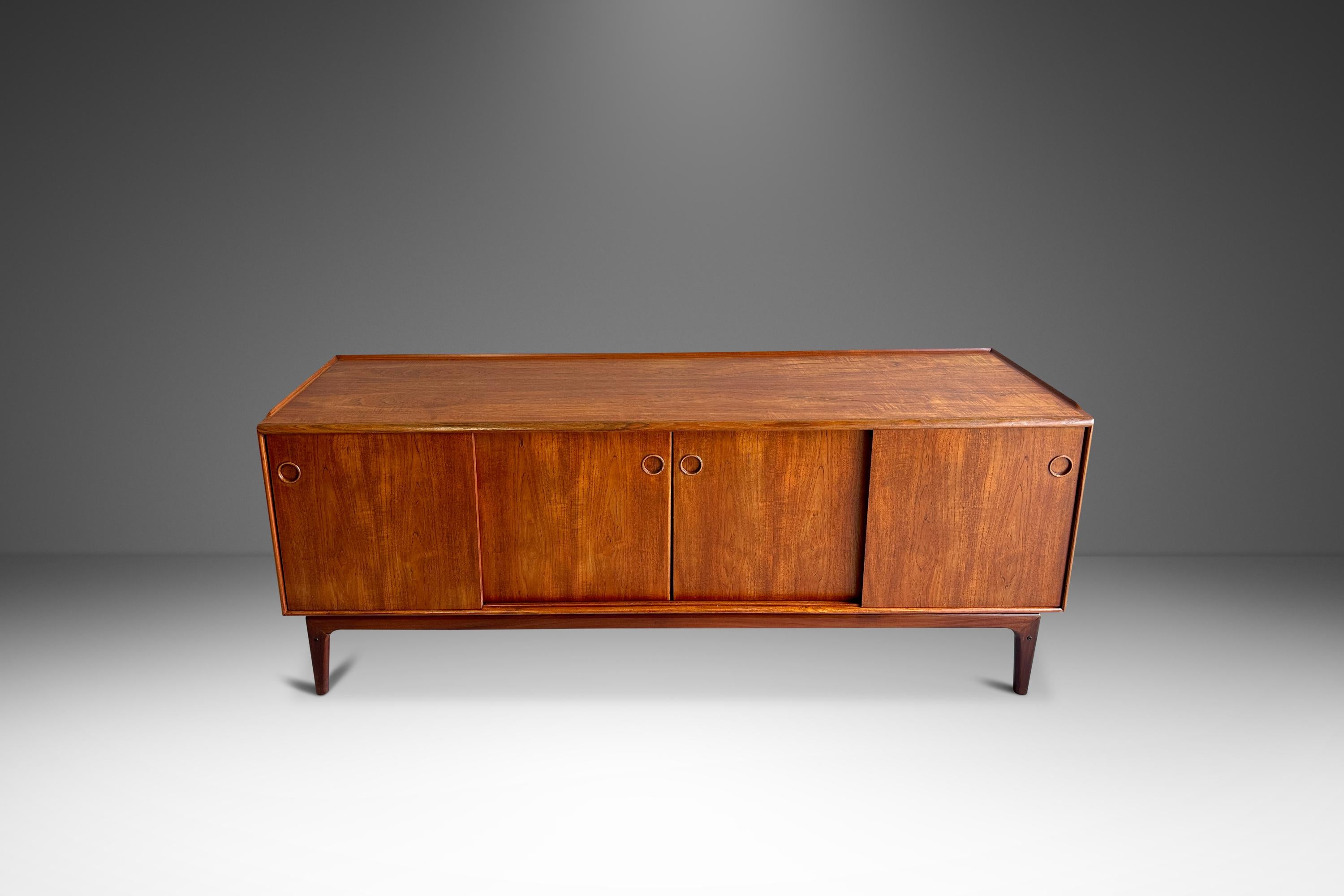 Presenting a remarkable teak sideboard designed by the renowned Arne Hovmand-Olsen for Mogens Kold. Crafted in Denmark during the 1960s, this piece exemplifies the finest of Danish Mid-Century Modern design. Featuring sleek, minimalist lines, a