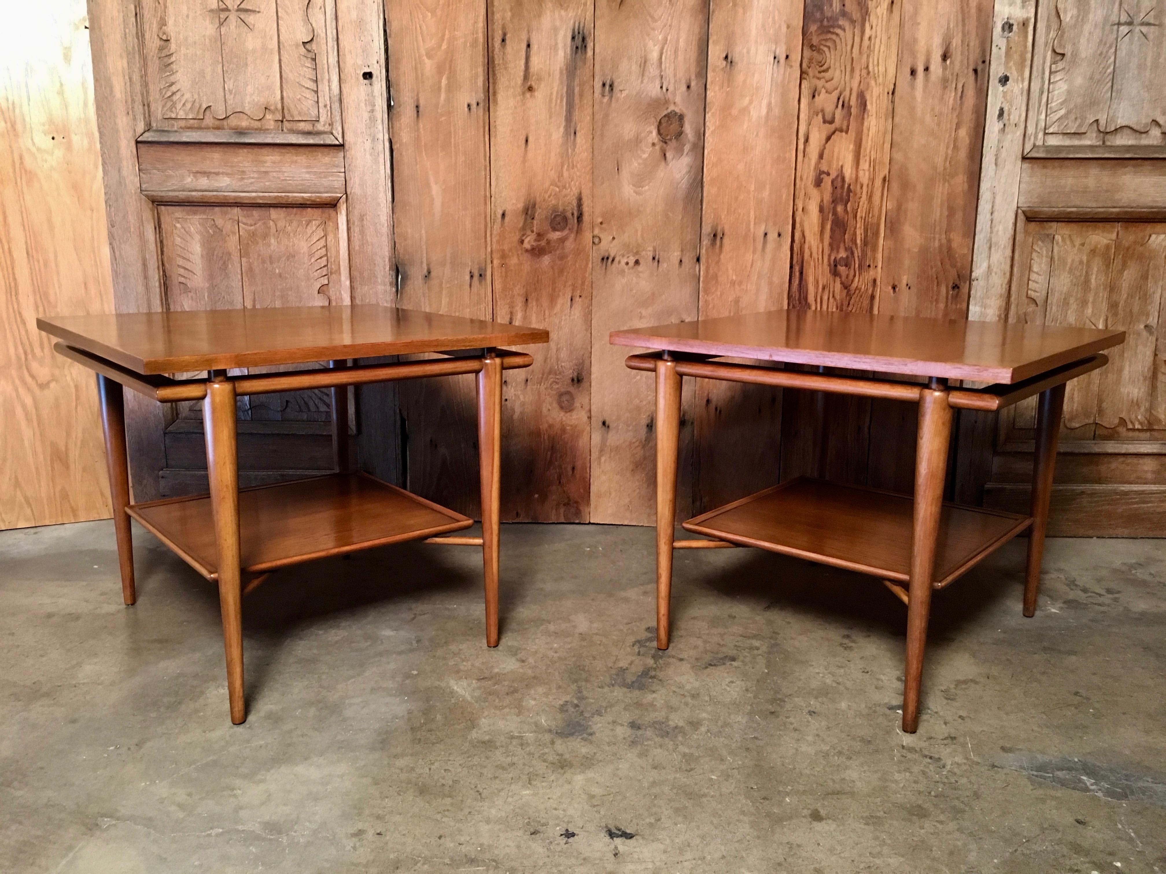 Pair of two-tiered end tables with floating tops in very good original finish.