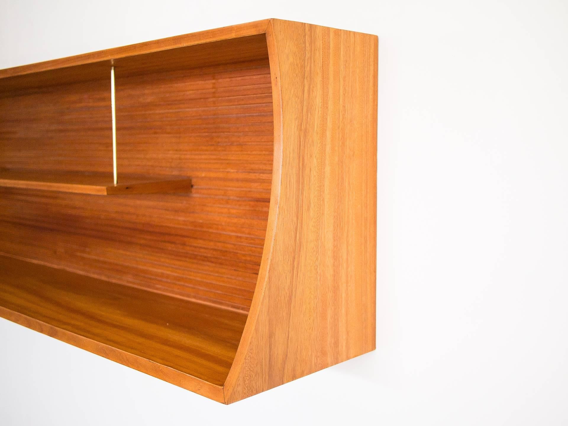 This beautiful shelving unit is reminiscent of the works of Joaquim Tenreiro and his made to order pieces. Borsoi was friends with Tenreiro and probably was heavily influenced by his work when creating the pieces for this house. 

Slatted back and
