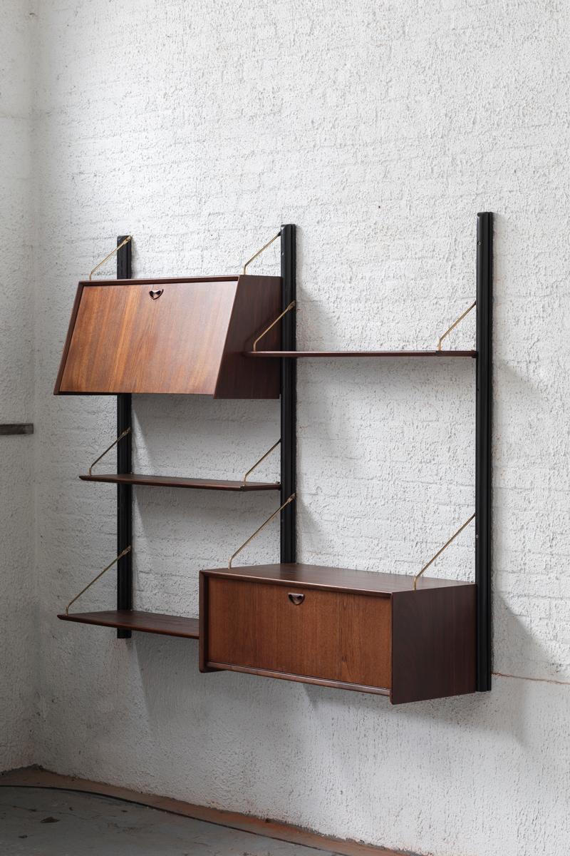Floating wall unit designed by Louis van Teeffelen and produced by Wébé in the Netherlands around 1960. This 2-piece wall unit has black wooden supports, 2 cabinets and shelfs from different depths, all in teak. All elements can be arranged as