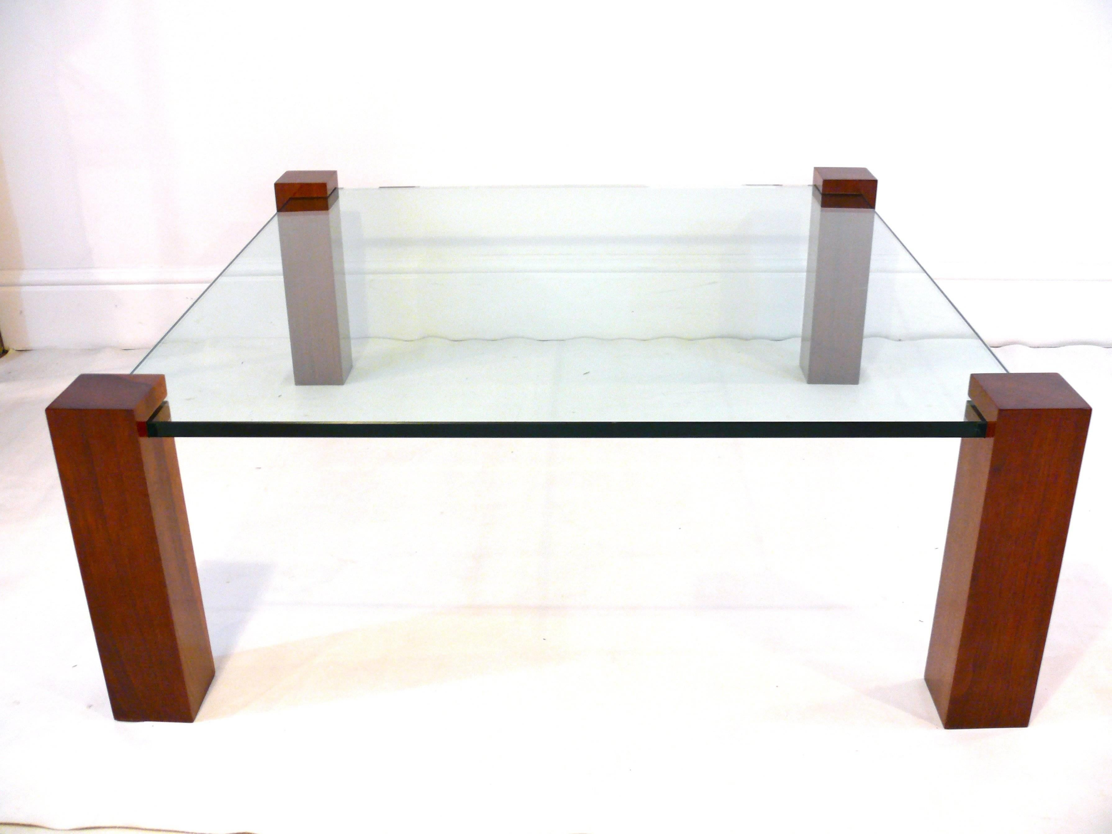 Floating walnut and glass coffee table. Shown with 42
