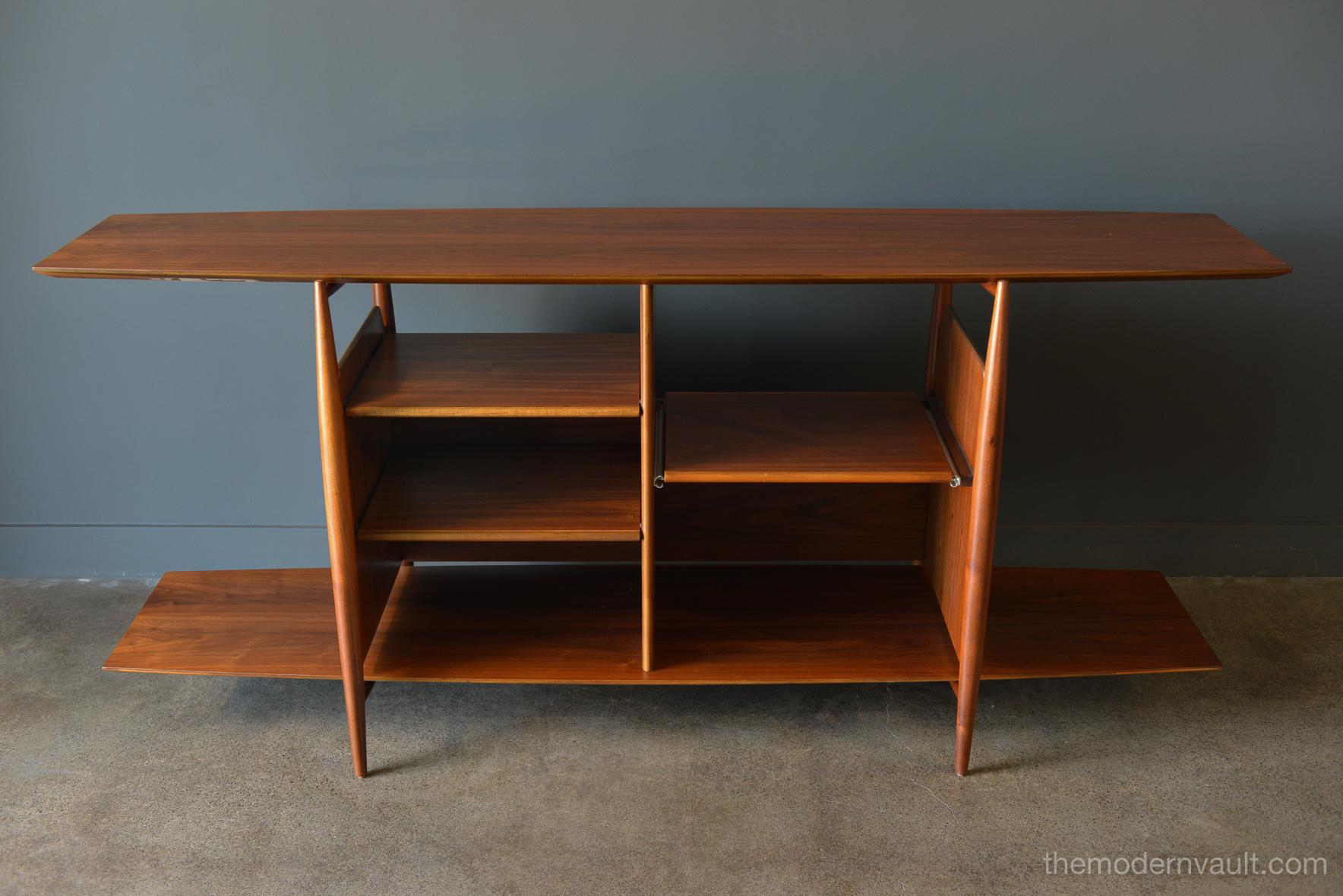 Floating walnut bookcase or media cabinet, circa 1965. Believed to be a Kipp Stewart/Stuart MacDougall design for Drexel. Rare, not often seen this piece has adjustable shelving on the left and a slide out shelf for your turntable or other media