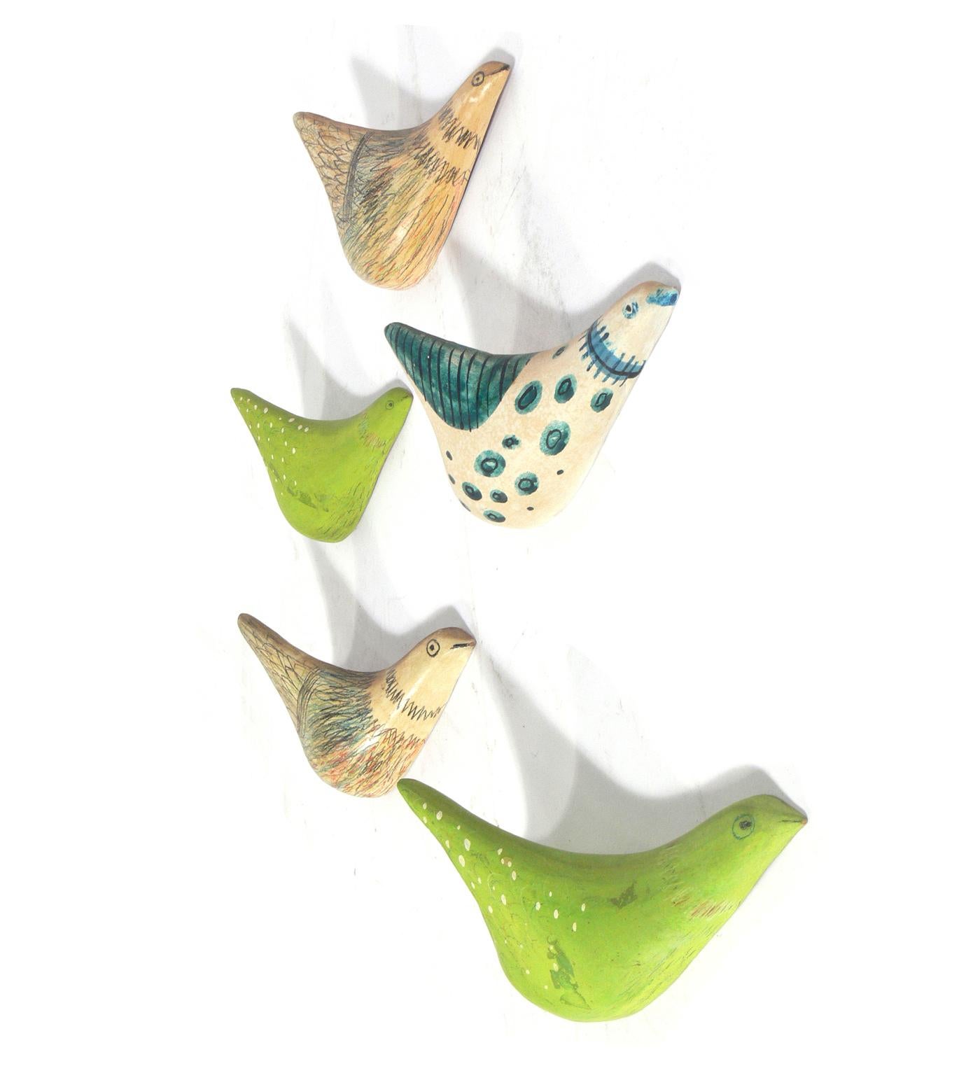Flock of Italian Ceramic Birds, Italy circa 1950s. They make a colorful wall mounted sculpture. The largest measures 9