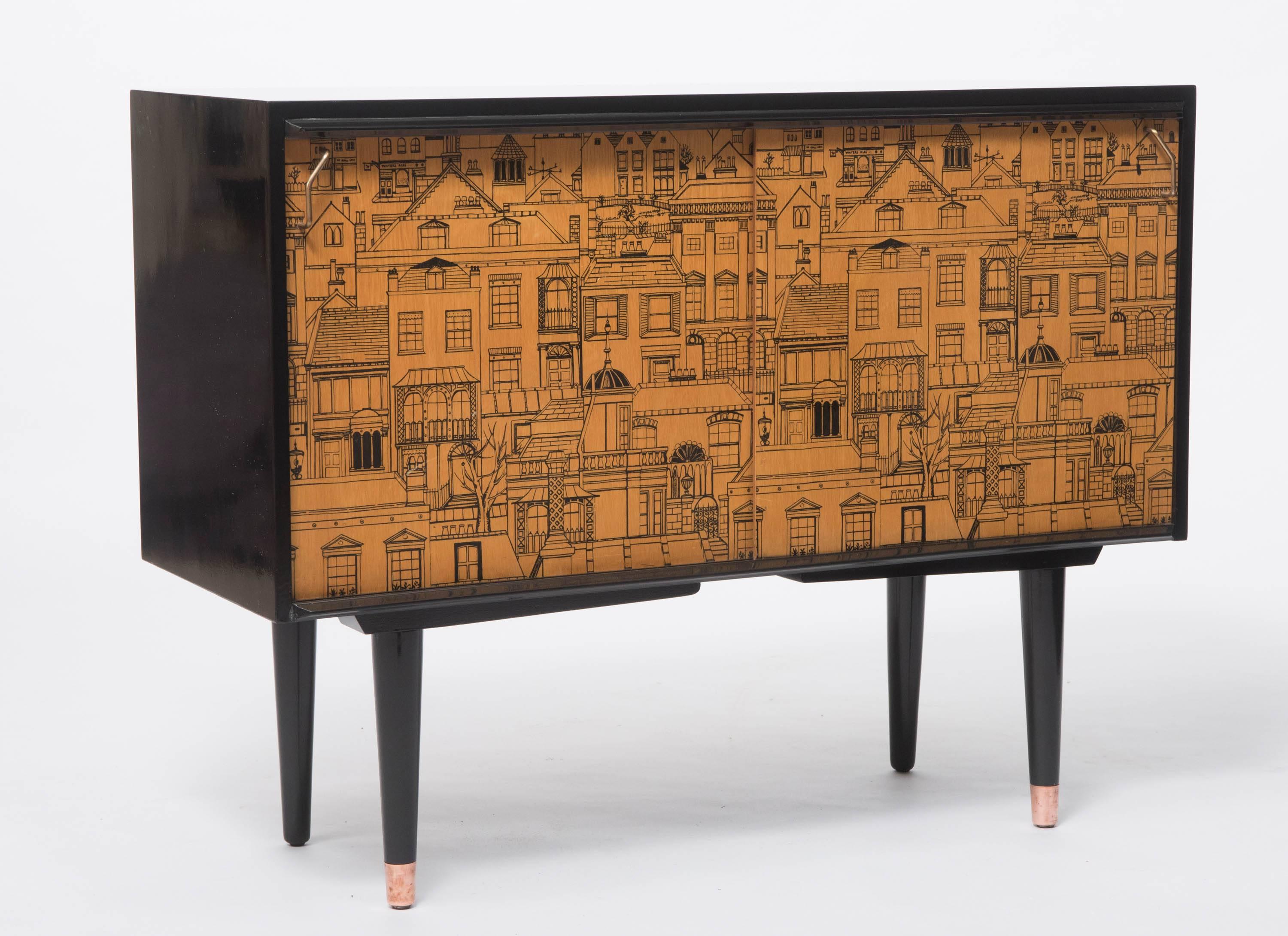 A rare cabinet by G.W. Evans and designed by Robert Heritage.
Model no. D.5542
The rectangular cabinet designed with sliding doors.
Printed with an architectural vignette designed by Dorothy Heritage.
Ebonized areas.
One side of the cabinet