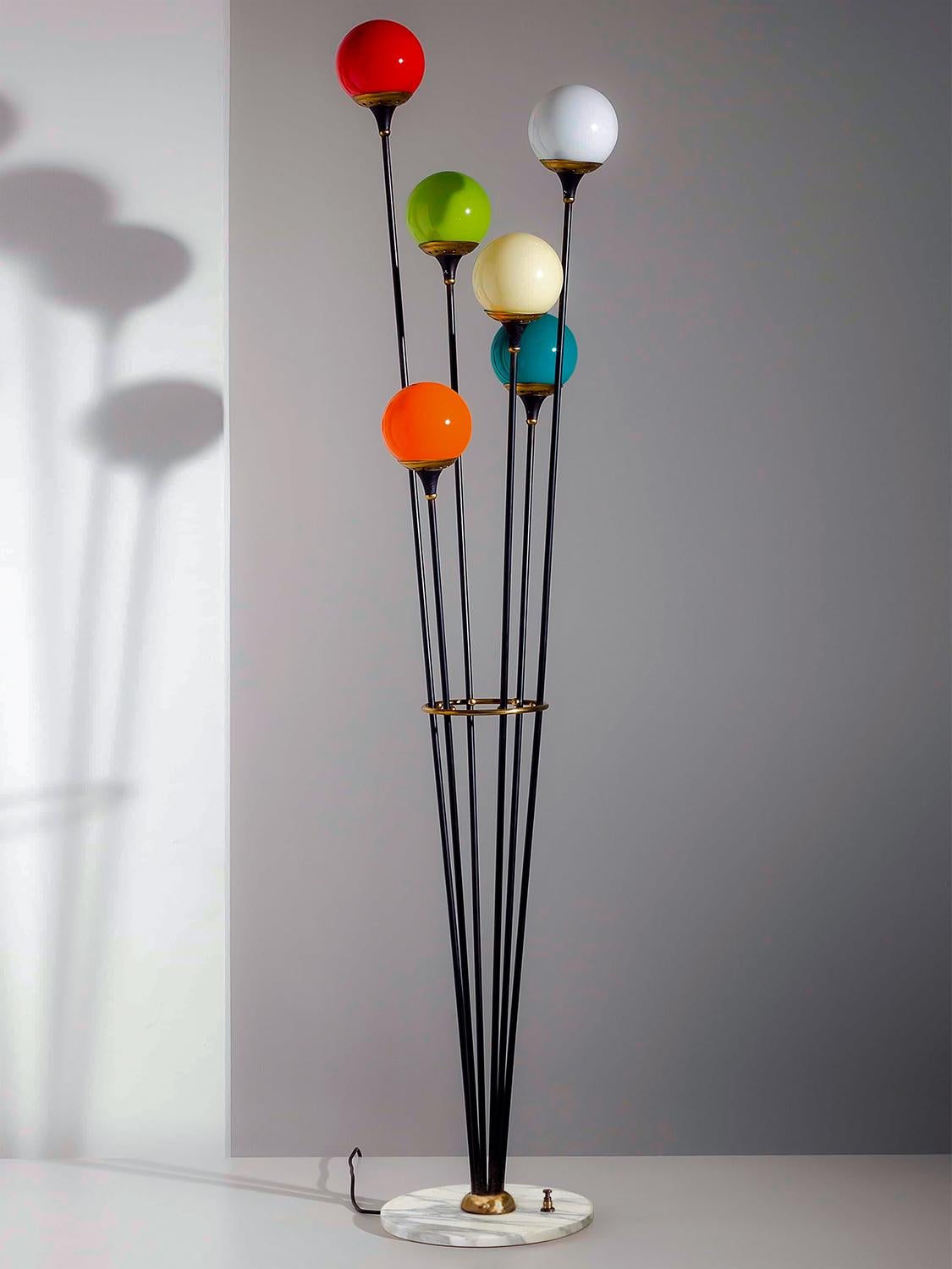 One of the most famous Stilnovo floor lamp six-lights, manufactured in Italy in the circa 1950.
Marble round base, black metal structure with six colored blown Murano glass balls, mounted on brass lampshades.
Its conditions of the period are to be